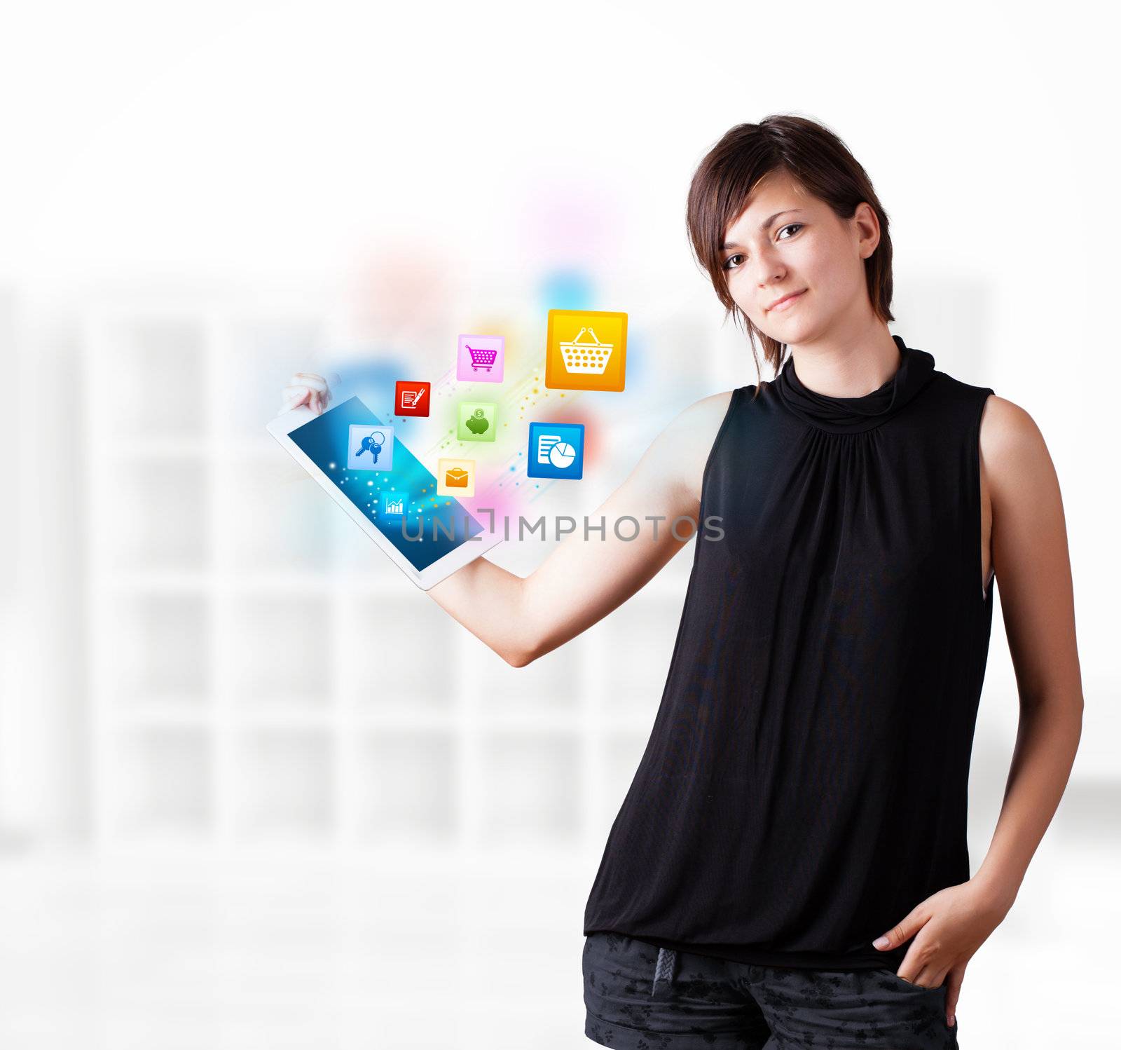 Young woman looking at modern tablet with colourful icons by ra2studio