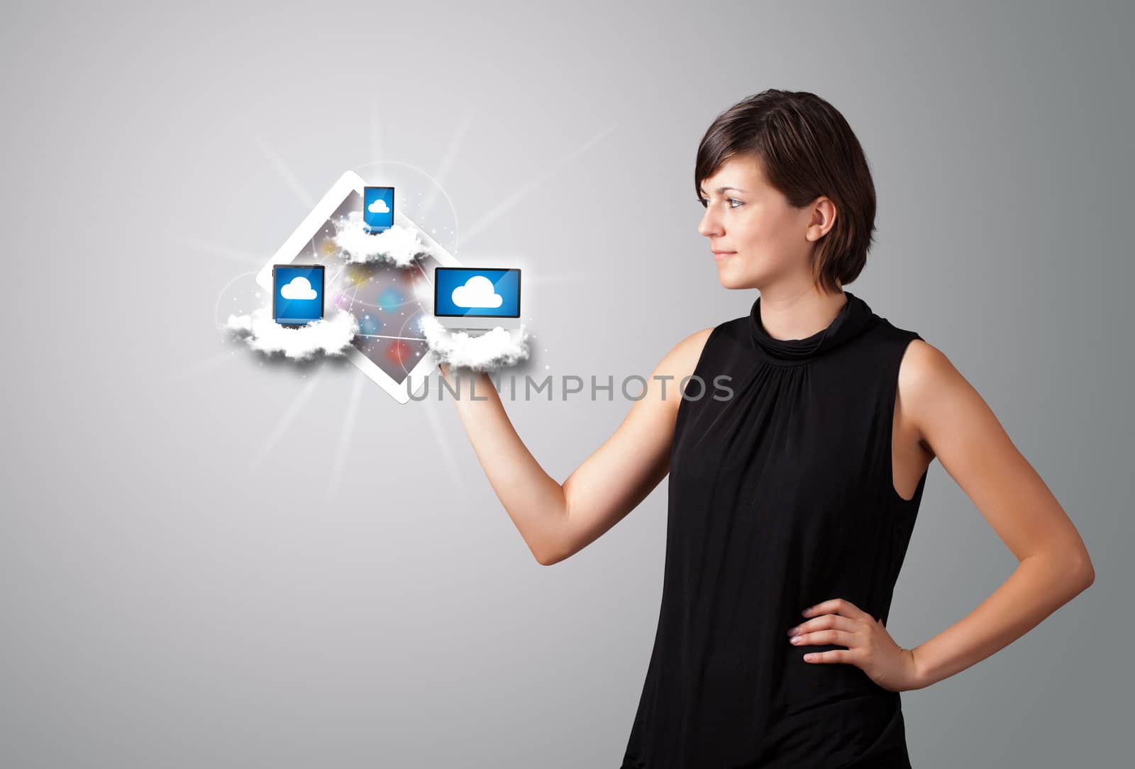 Beautiful young woman holding tablet with modern devices in clouds