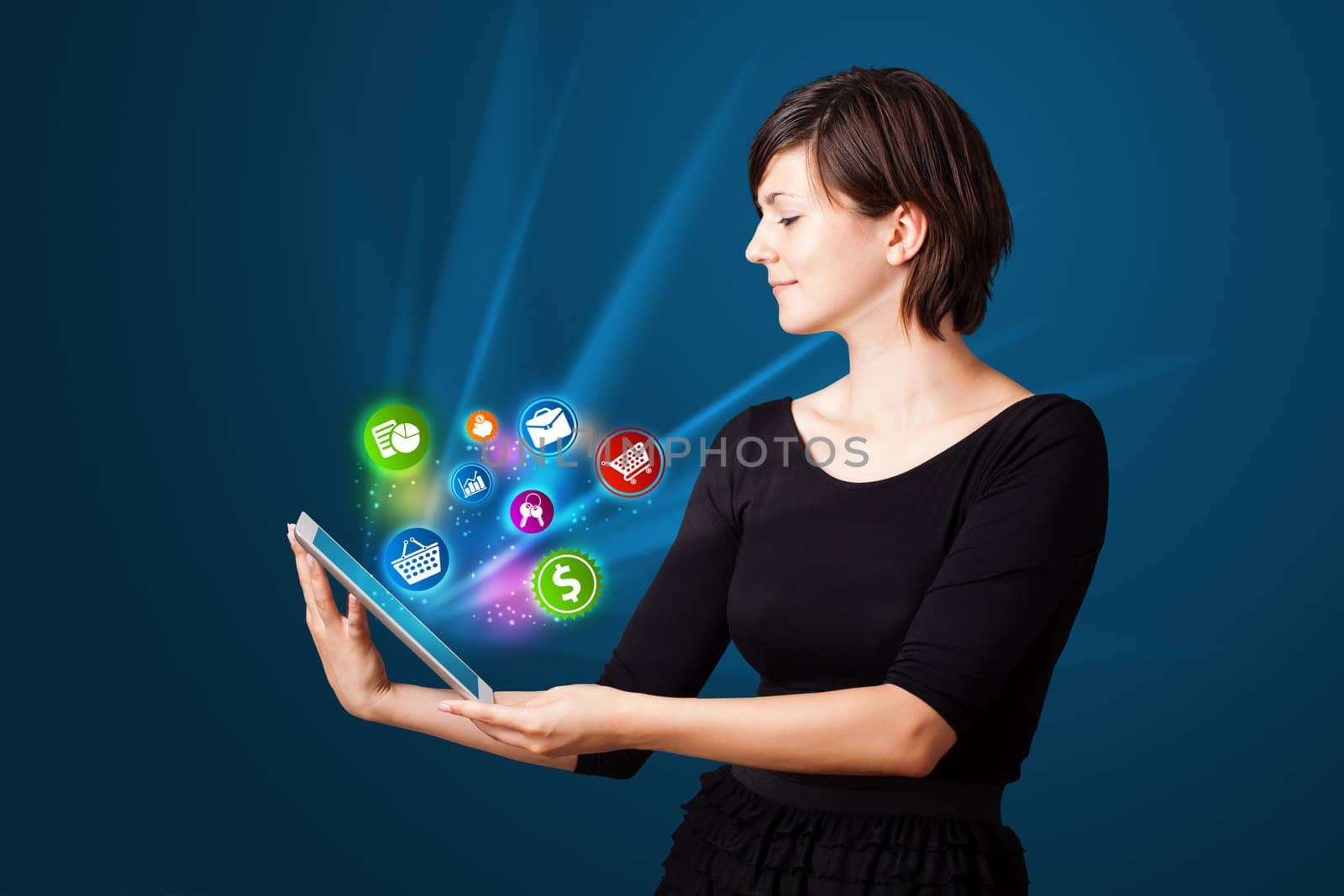 Young business woman looking at modern tablet with abstract lights and various icons