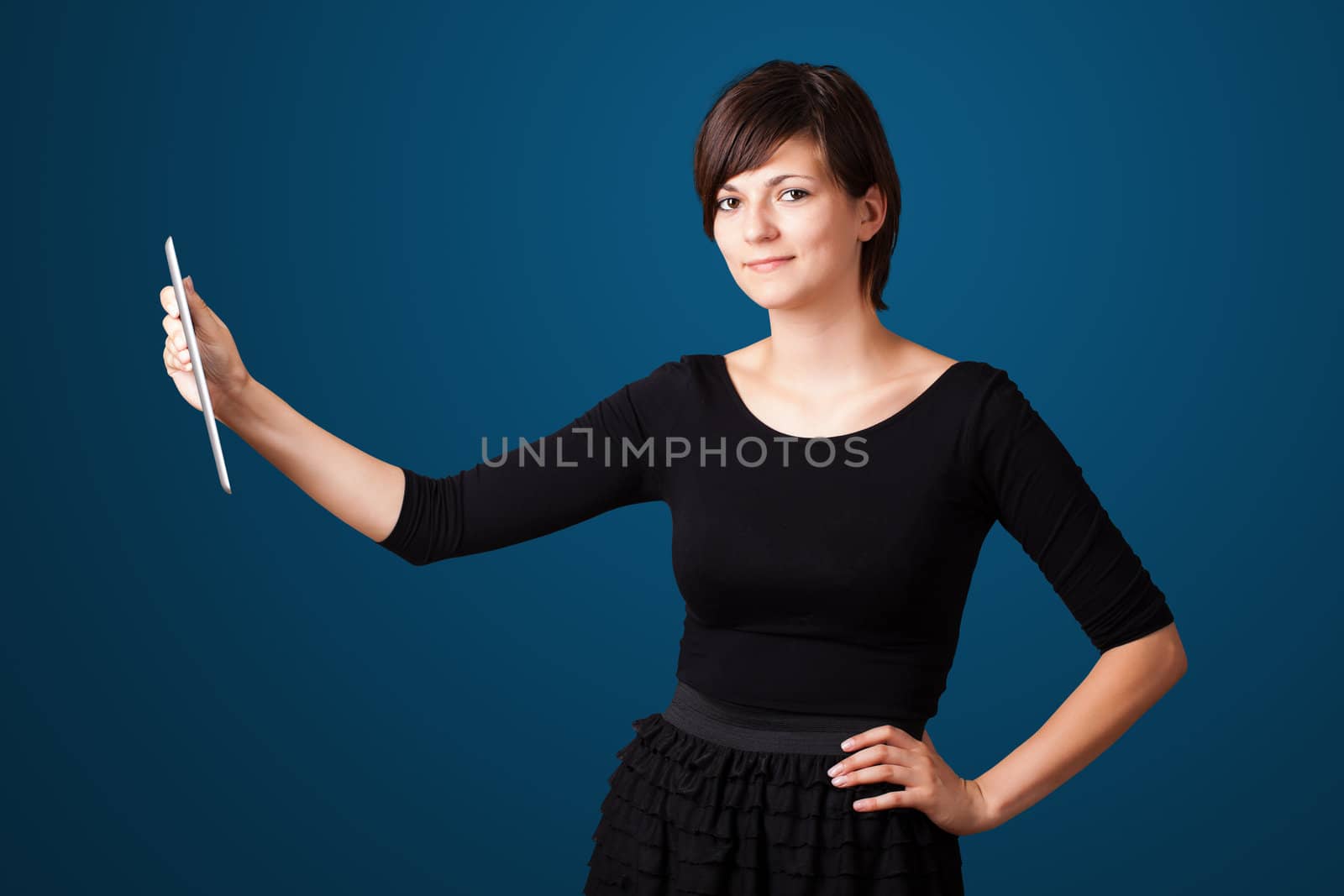 Young business woman looking at modern tablet 