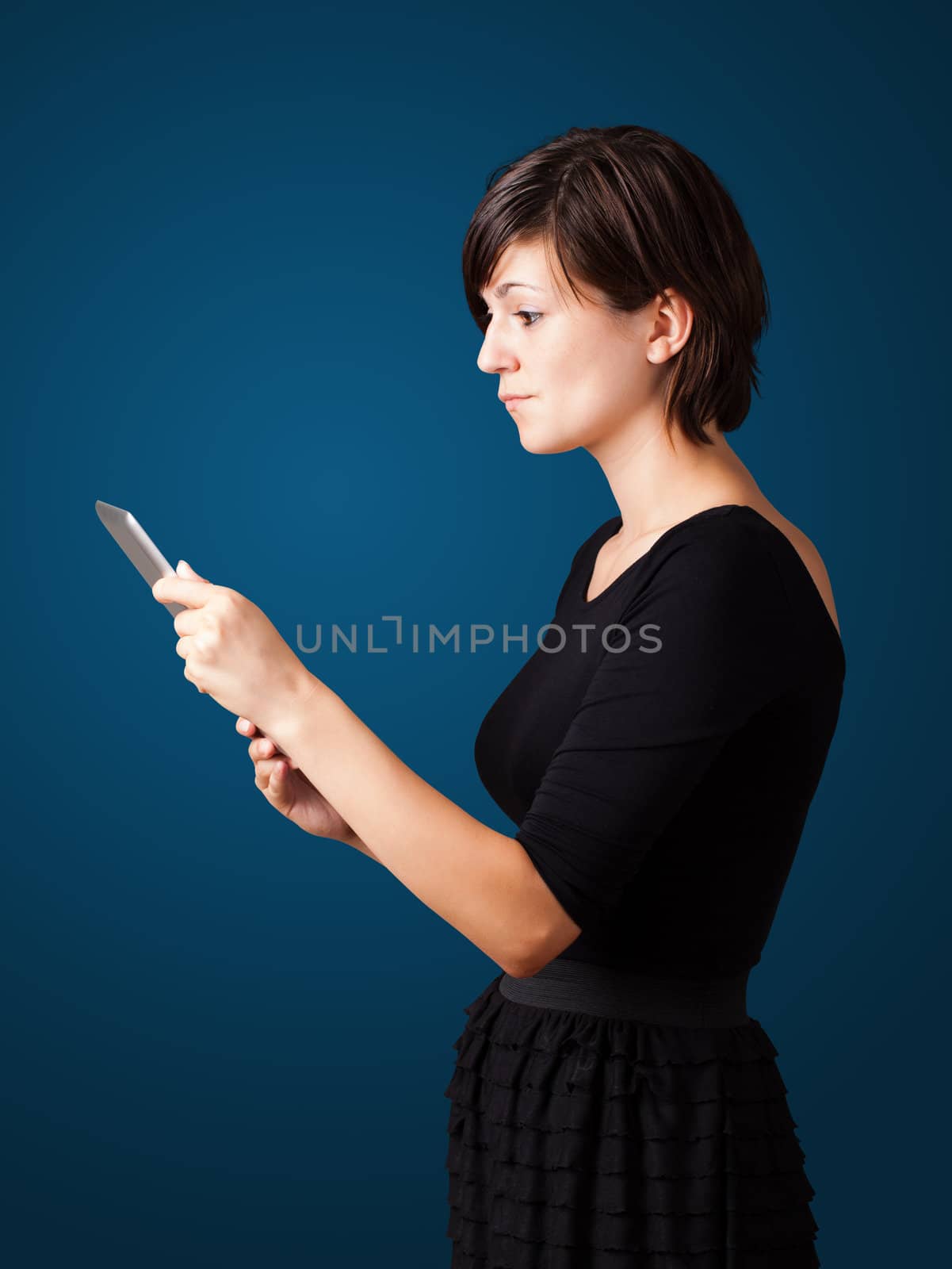 Young business woman looking at modern tablet 