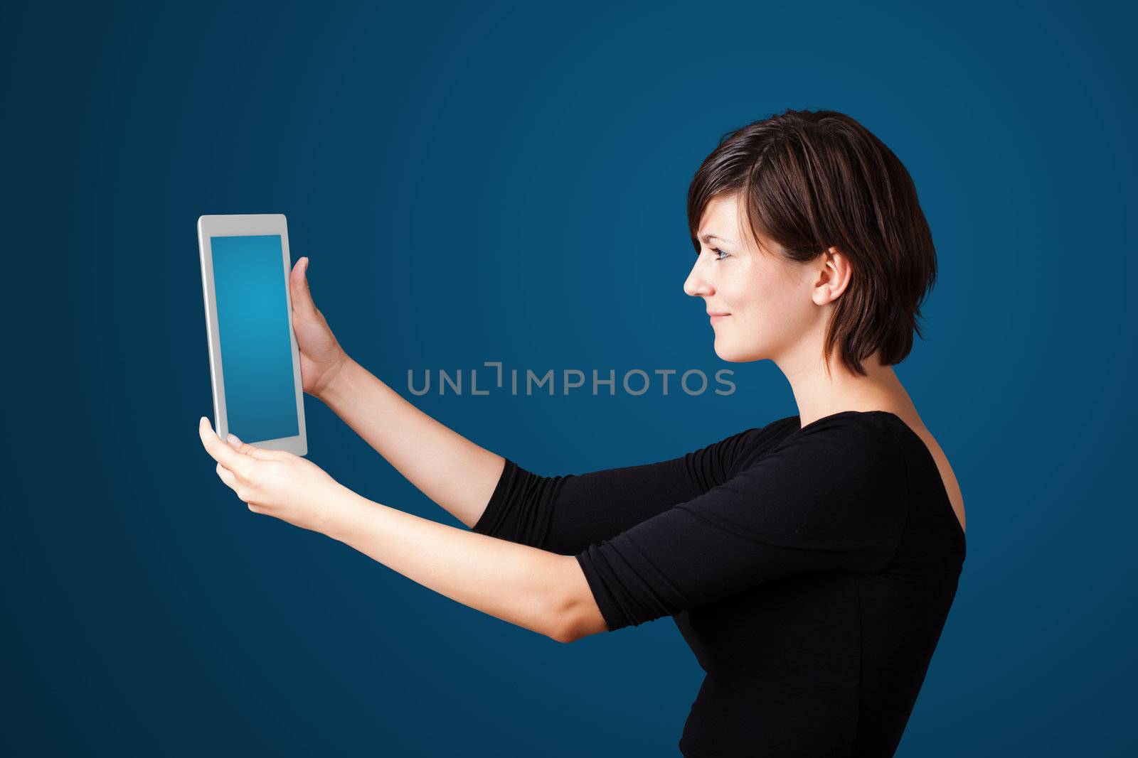 Young business woman looking at modern tablet 