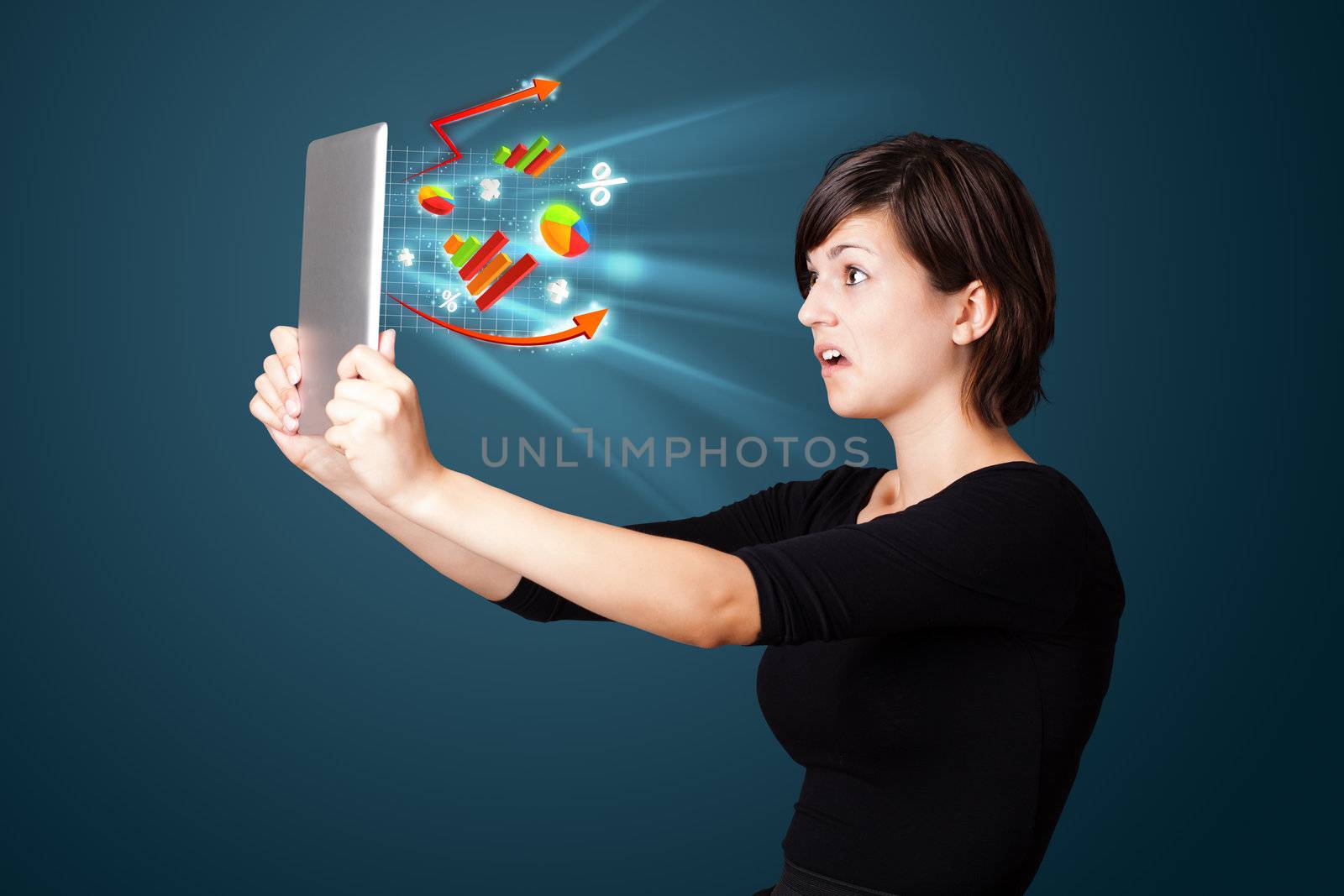 Young business woman looking at modern tablet with abstract lights and various diagrams