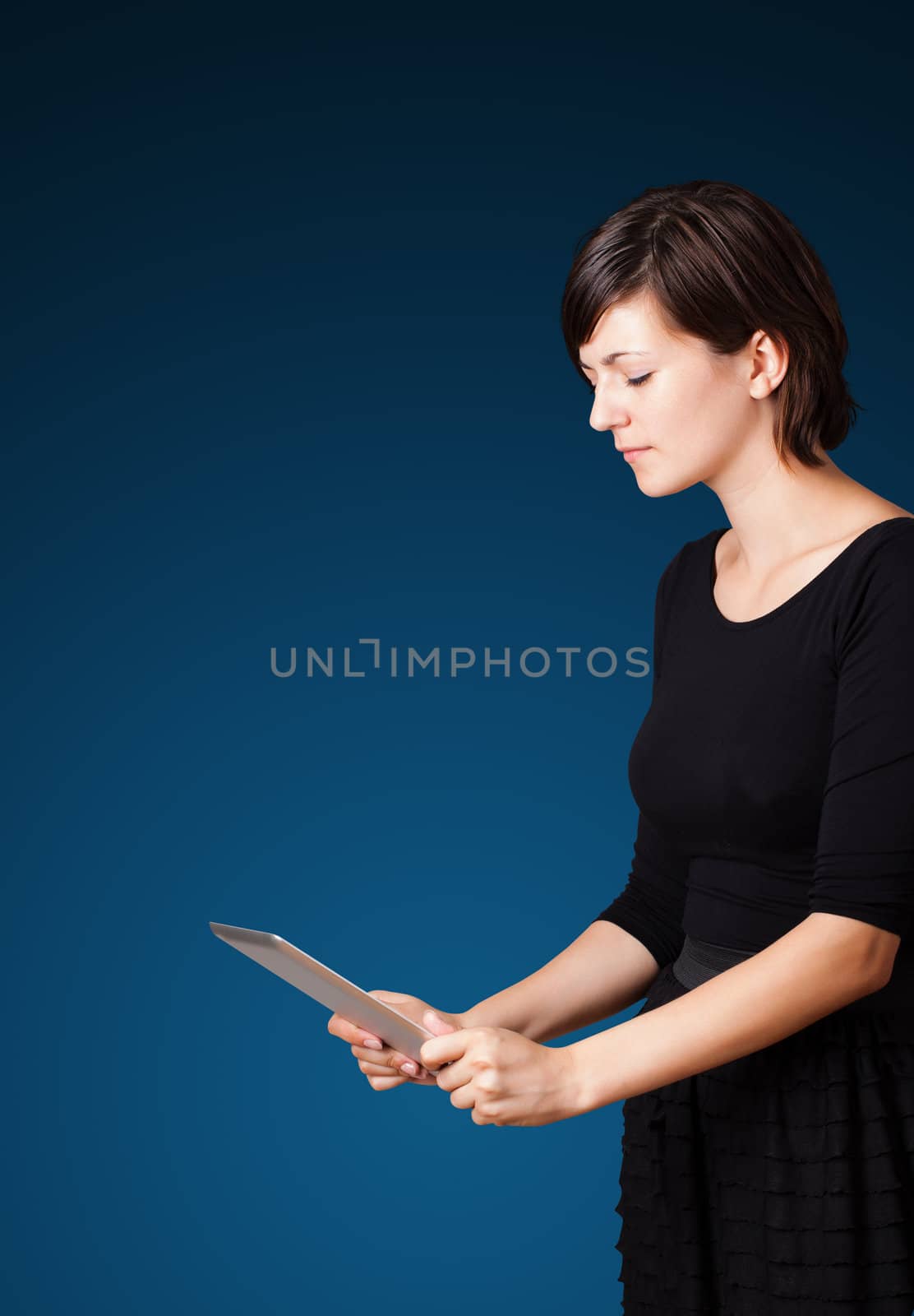 Young business woman looking at modern tablet 