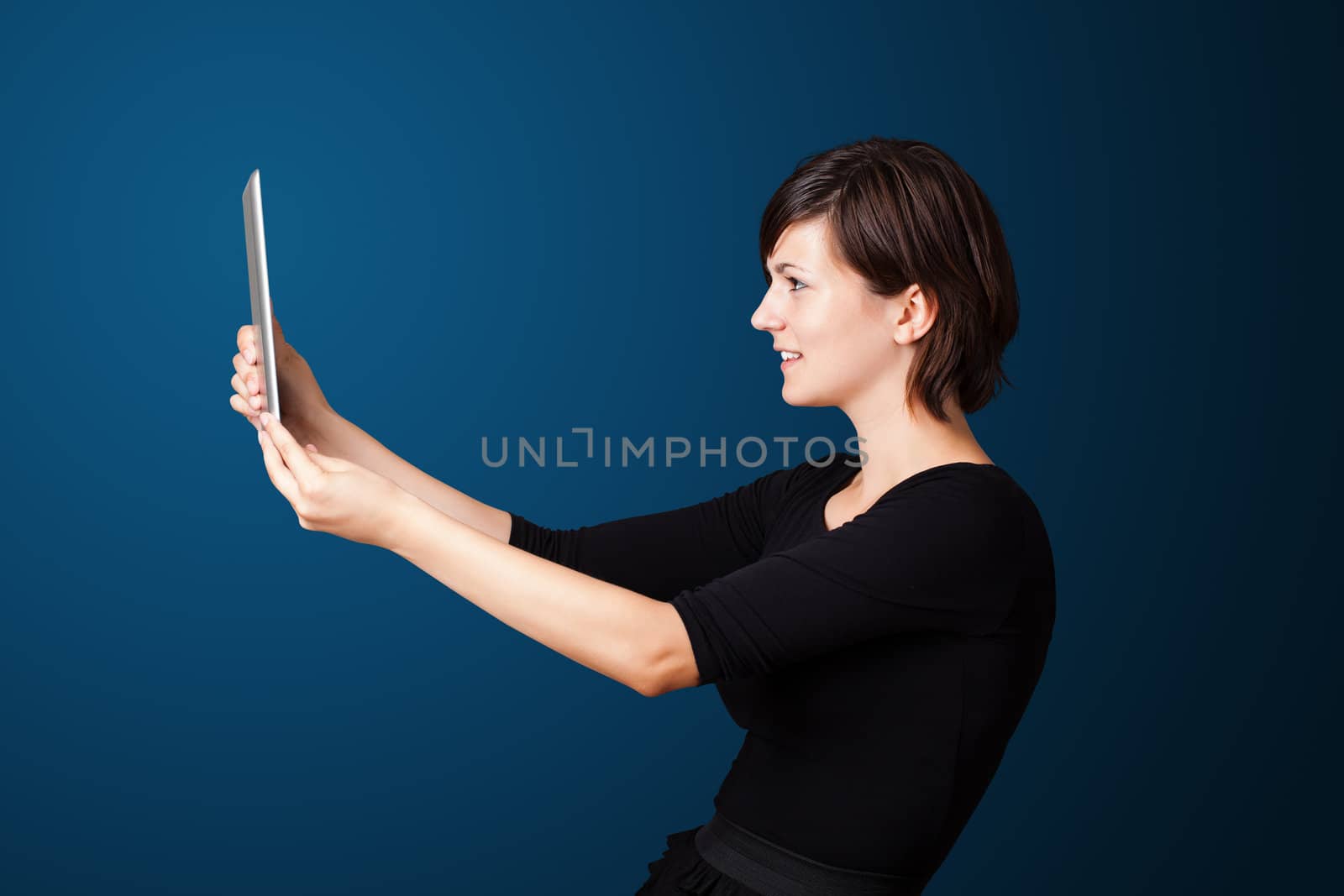 Young business woman looking at modern tablet 