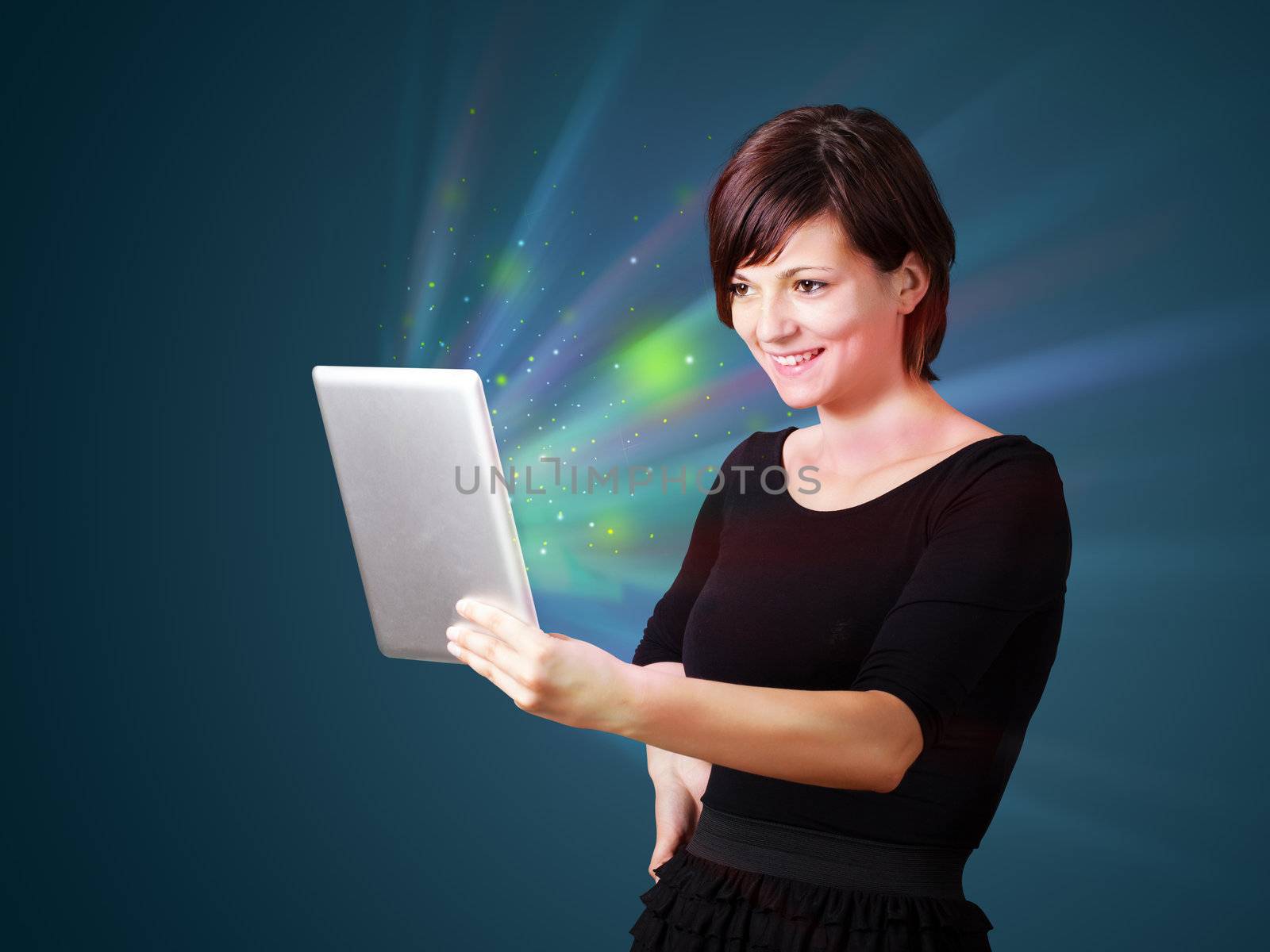 Young business woman looking at modern tablet with abstract lights 