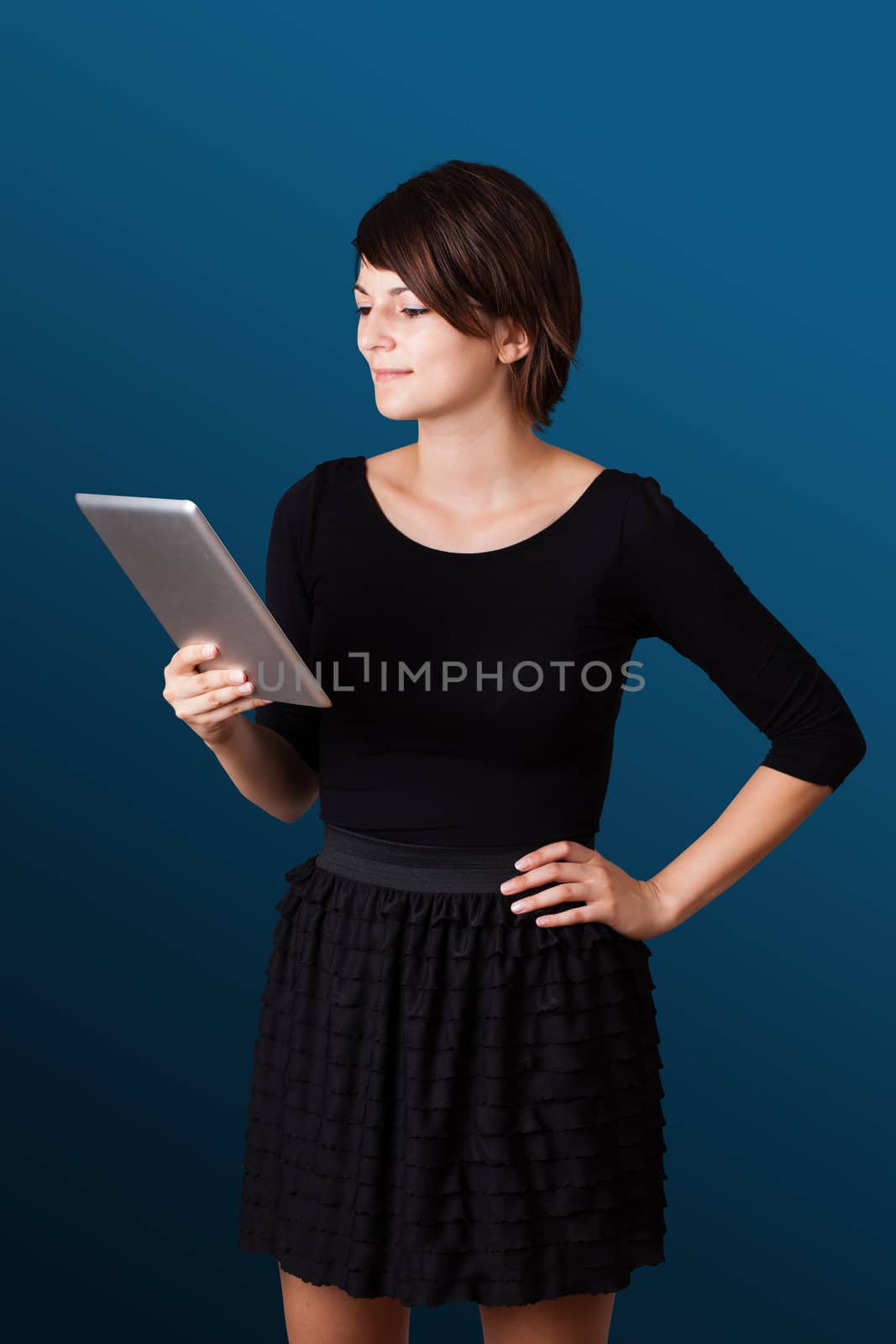 Young business woman looking at modern tablet 