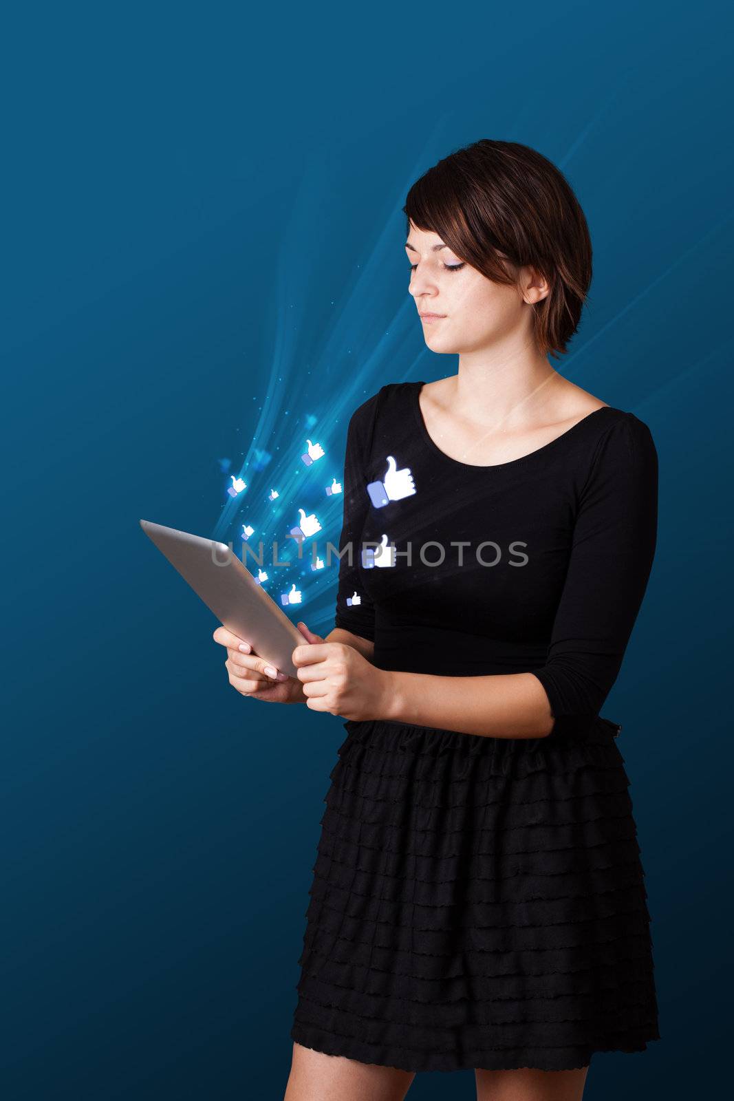 Young woman looking at modern tablet with abstract lights and so by ra2studio