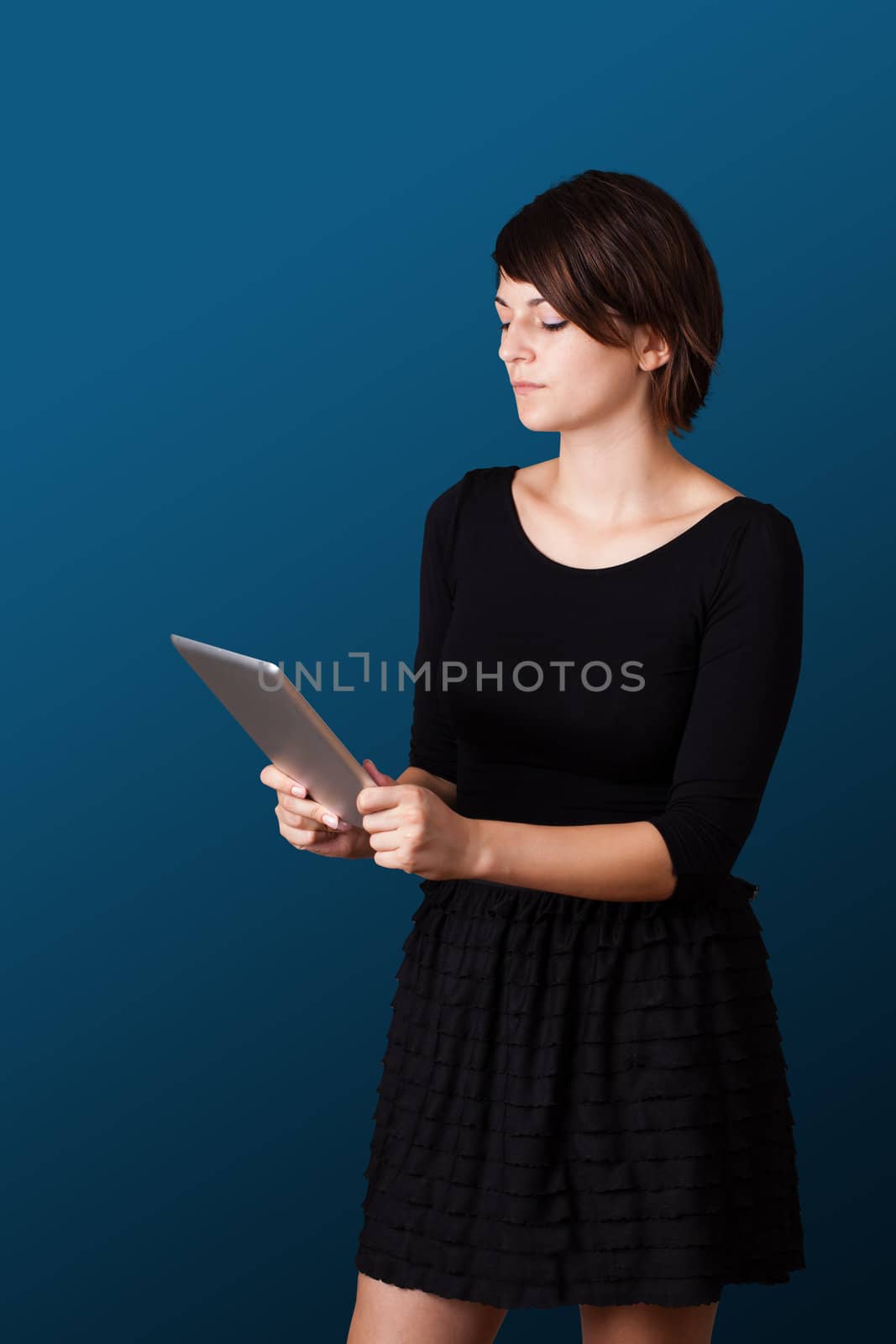 Young business woman looking at modern tablet 