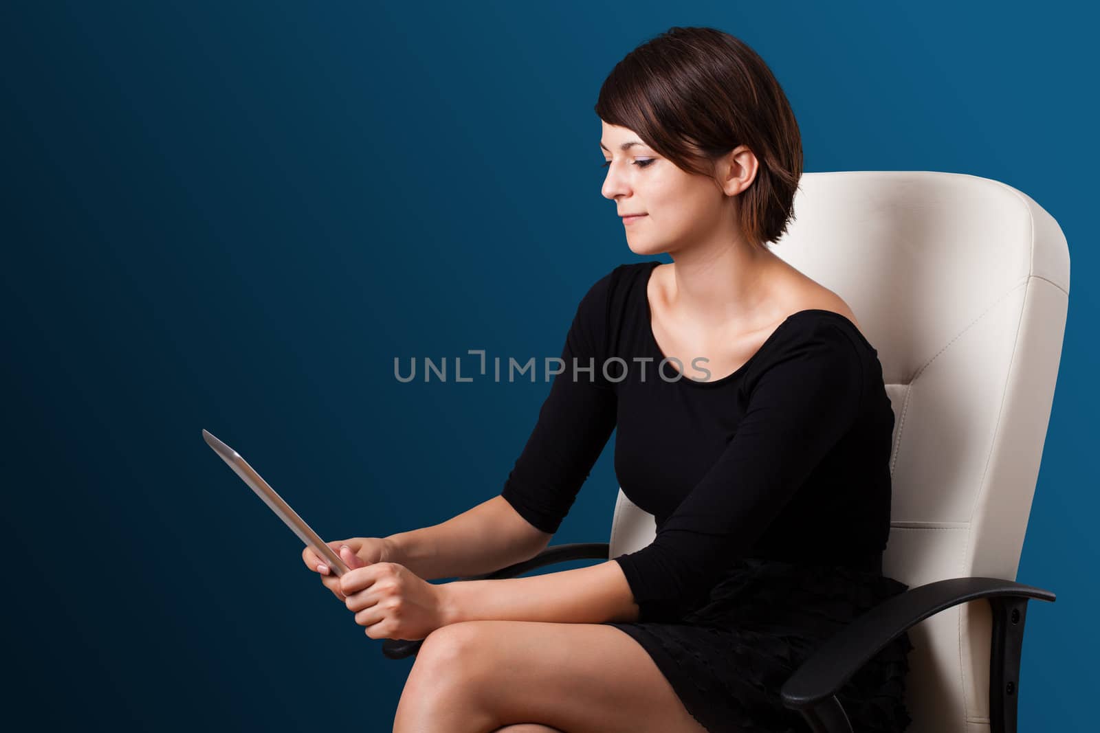 Young business woman looking at modern tablet 