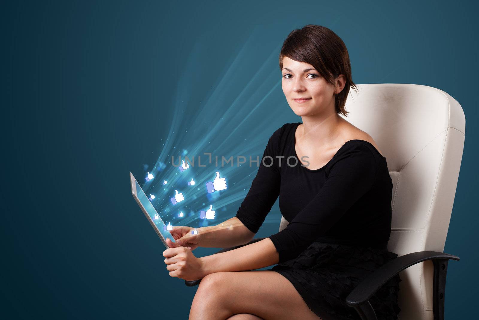 Young business woman looking at modern tablet with abstract lights and social icons