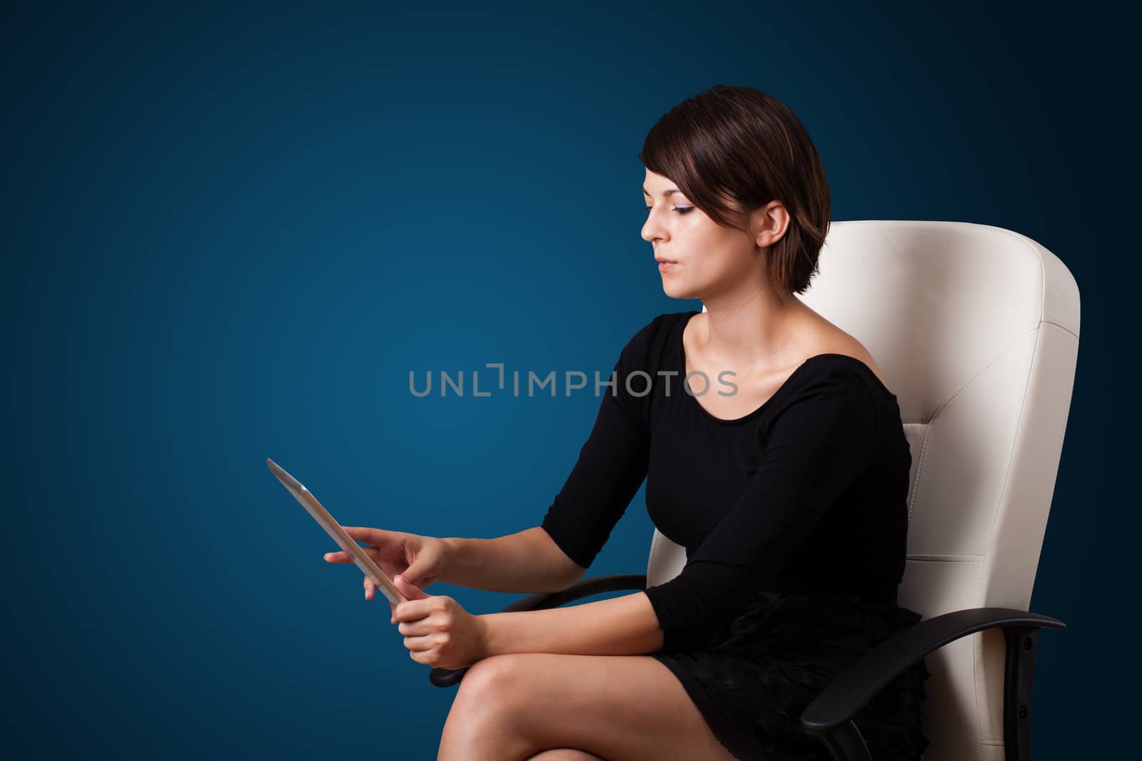 Young business woman looking at modern tablet 