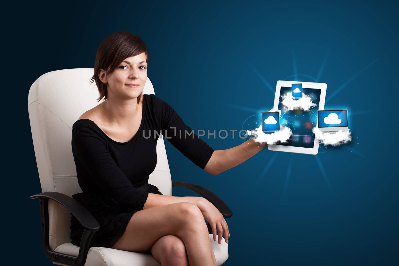 Beautiful young woman holding tablet with modern devices in clouds