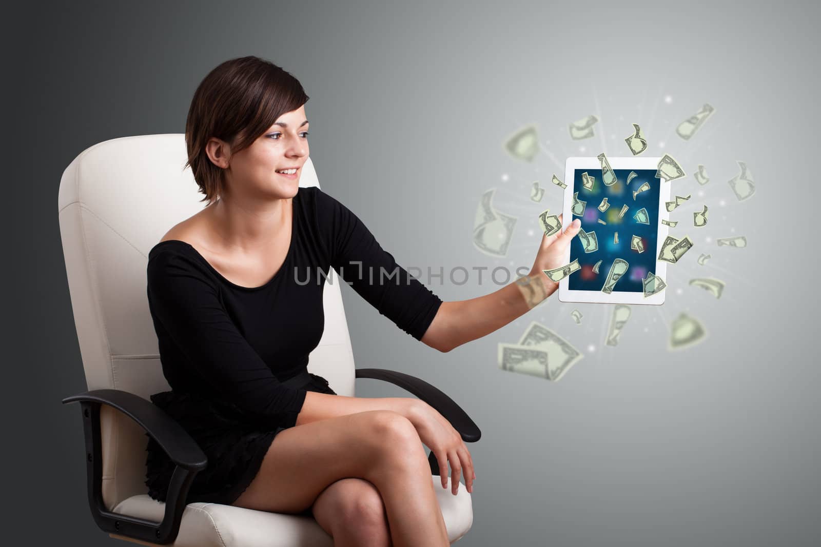 beautiful young woman holding tablet with money