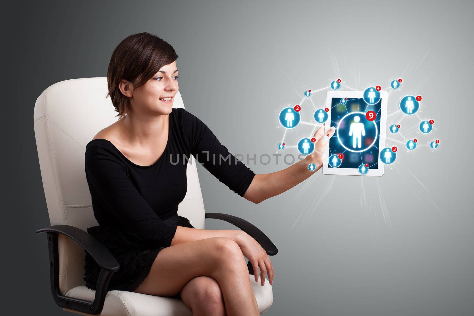 Beautiful young woman holding tablet with social network icons