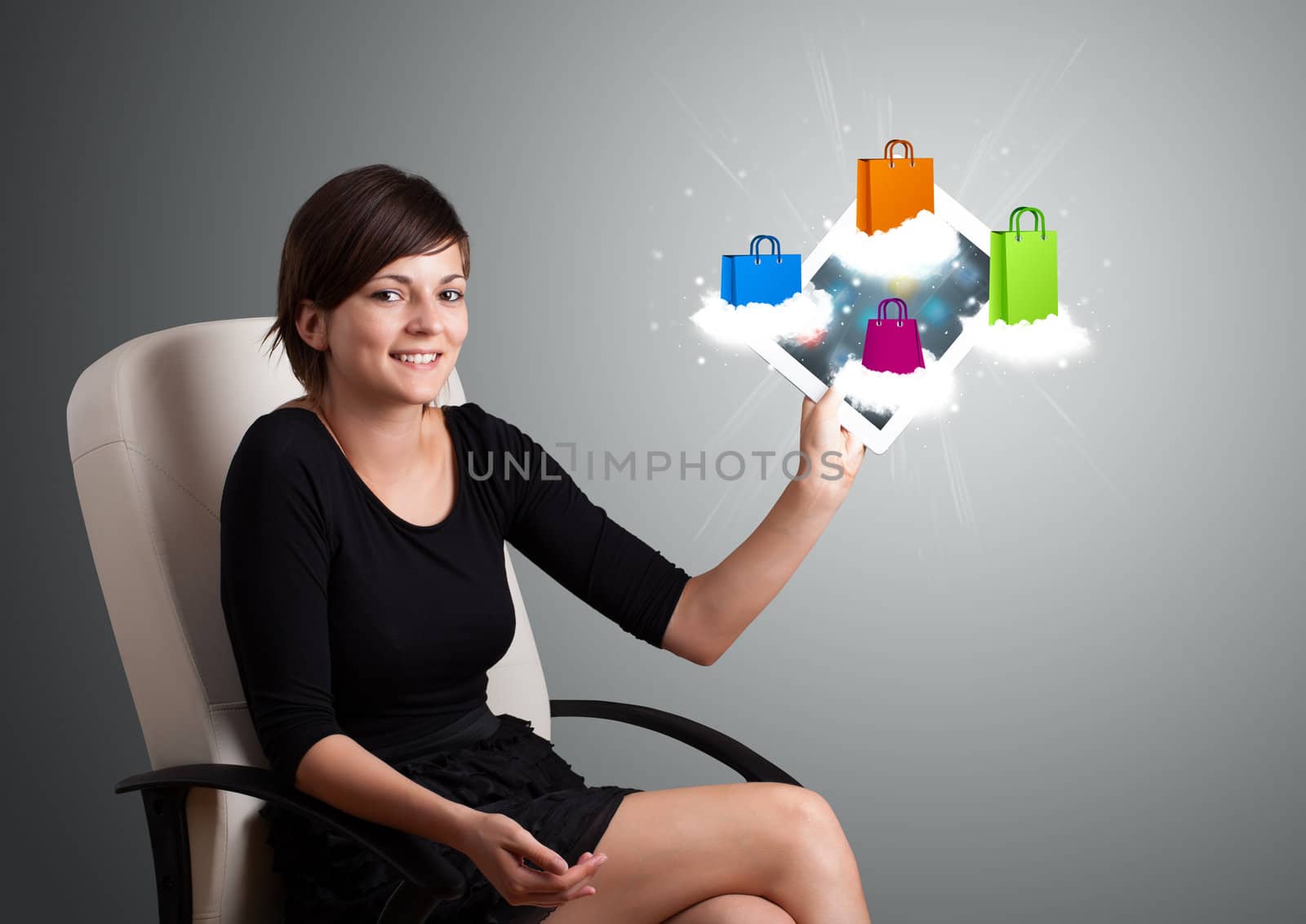 woman holding modern tablet with colorful shopping bags on cloud by ra2studio