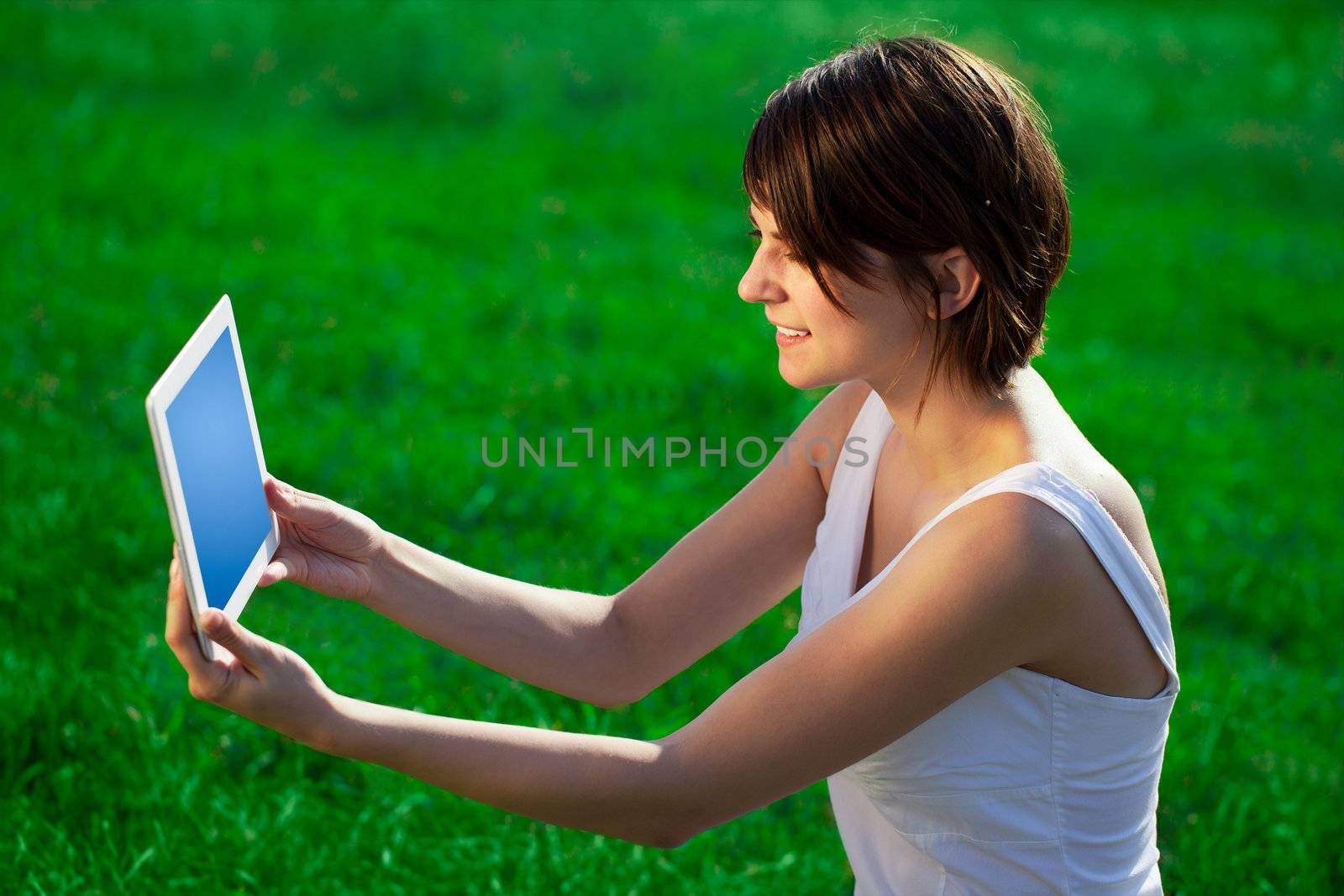 Young business woman looking at modern tablet 