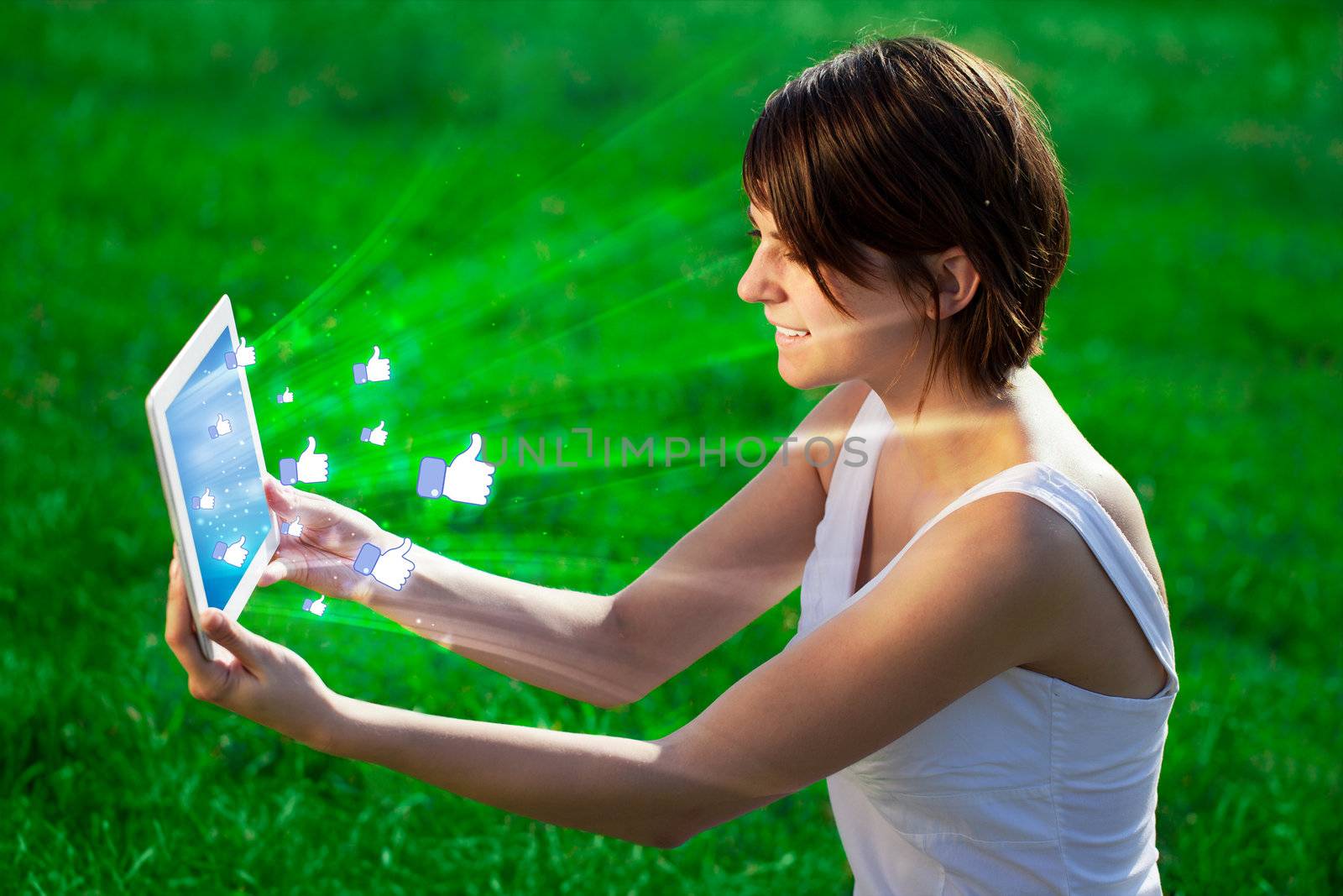 Young woman looking at modern tablet with abstract lights and so by ra2studio