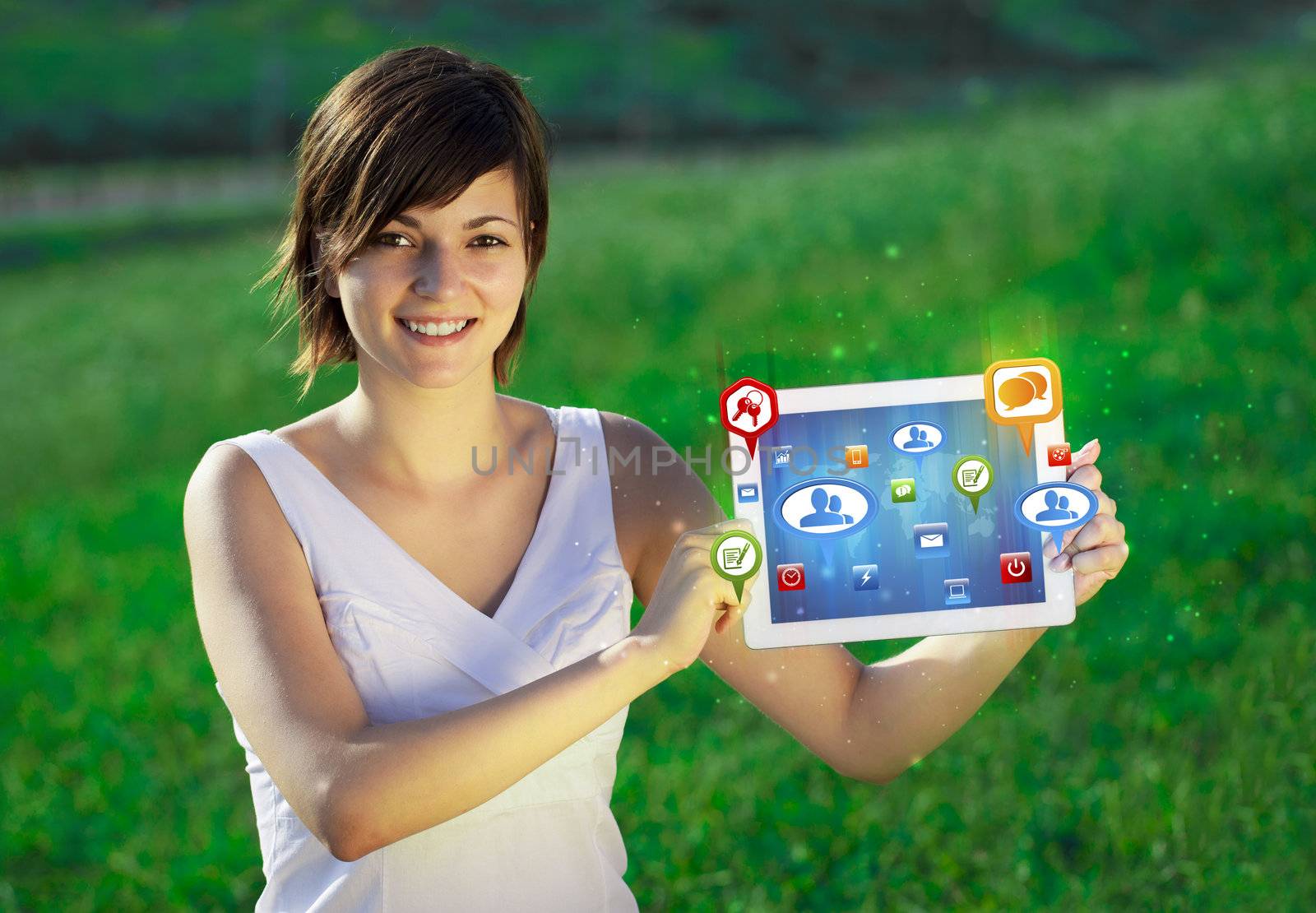 Young business woman looking at modern tablet with abstract lights and social icons