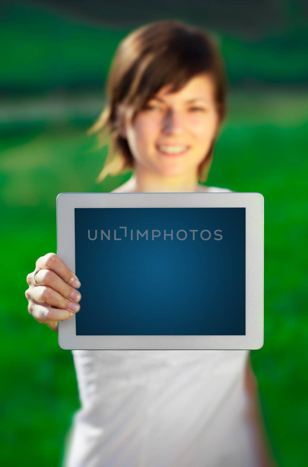 Young business woman looking at modern tablet 