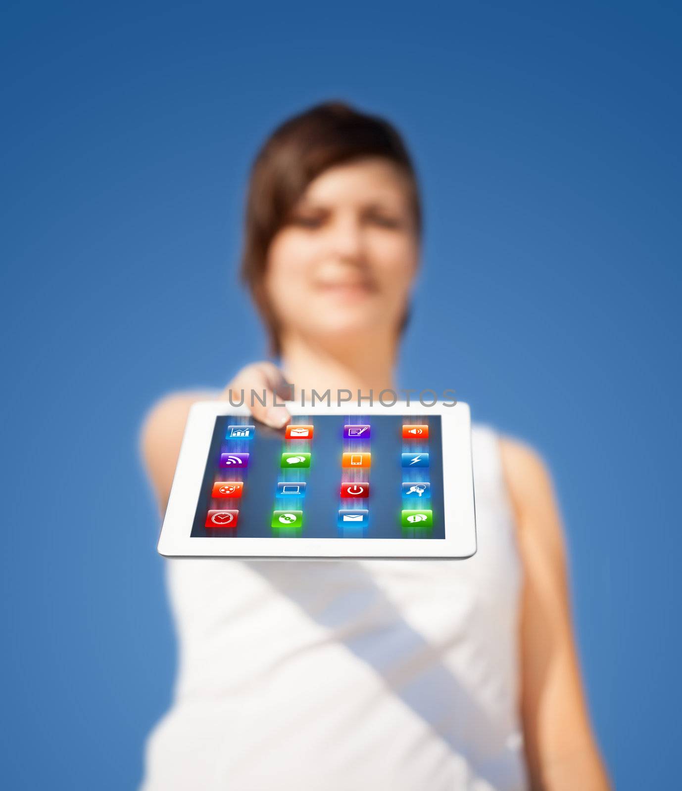 Young business woman looking at modern tablet with abstract lights and various icons