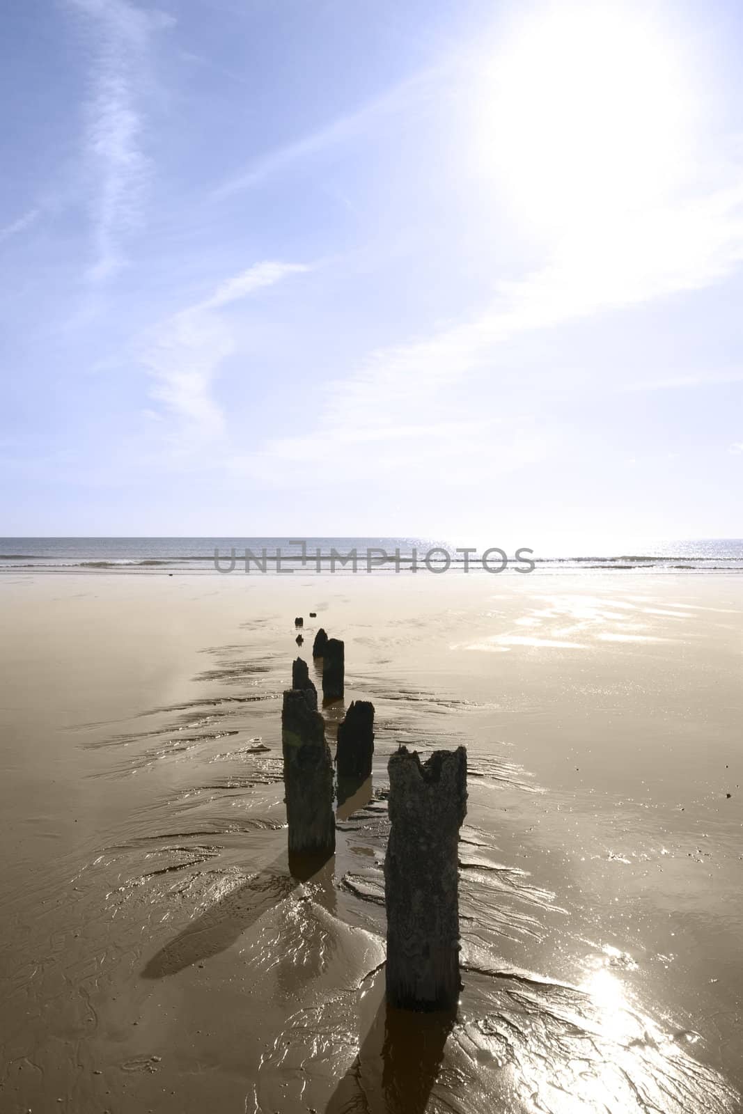 sunshine over the beach breakers in Youghal county Cork Ireland on a summers day