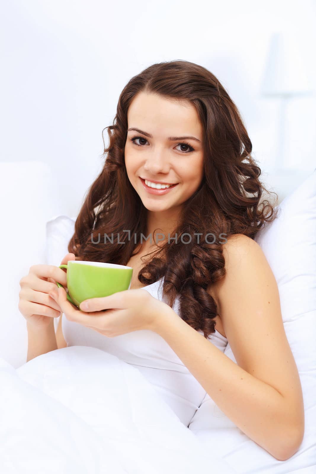 Portrait of lovely young woman having cup of tea at home