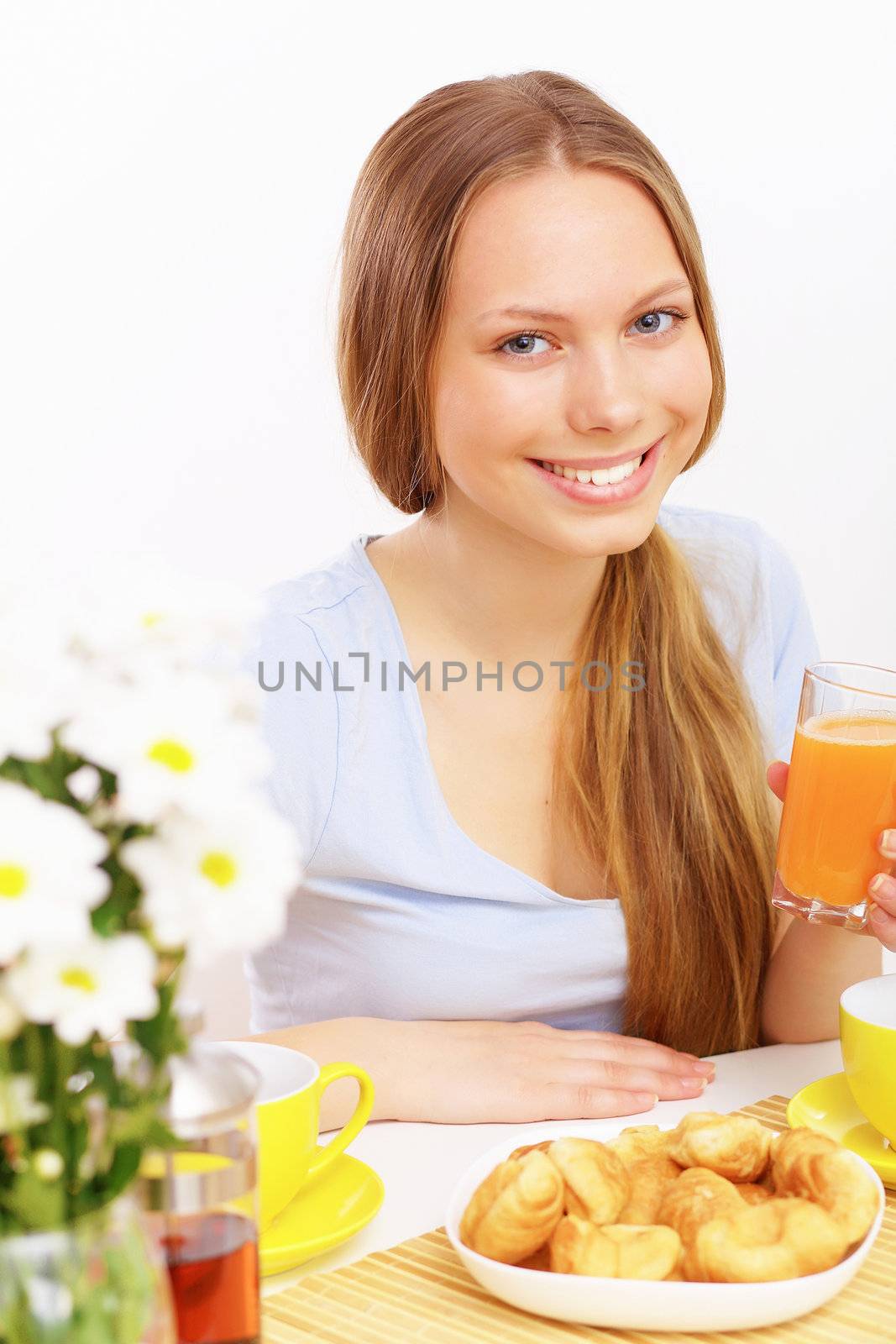 Beautiful young woman drinking tea from yellow cup