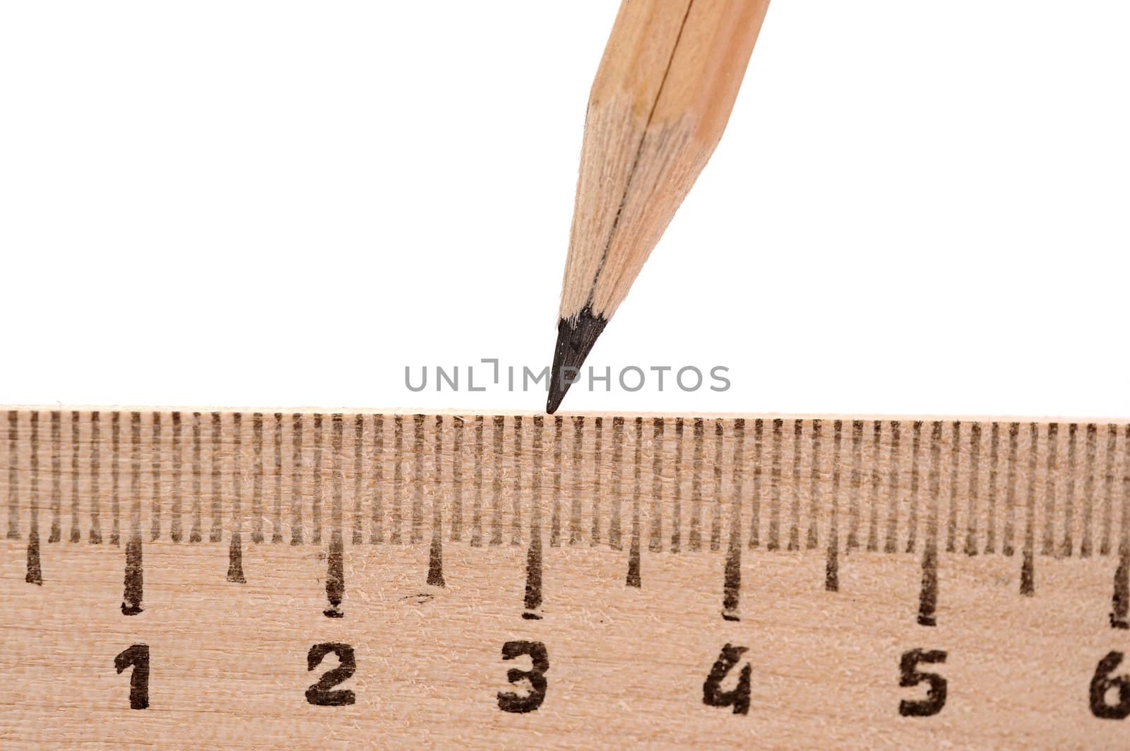 ruler and wood pencil on white 