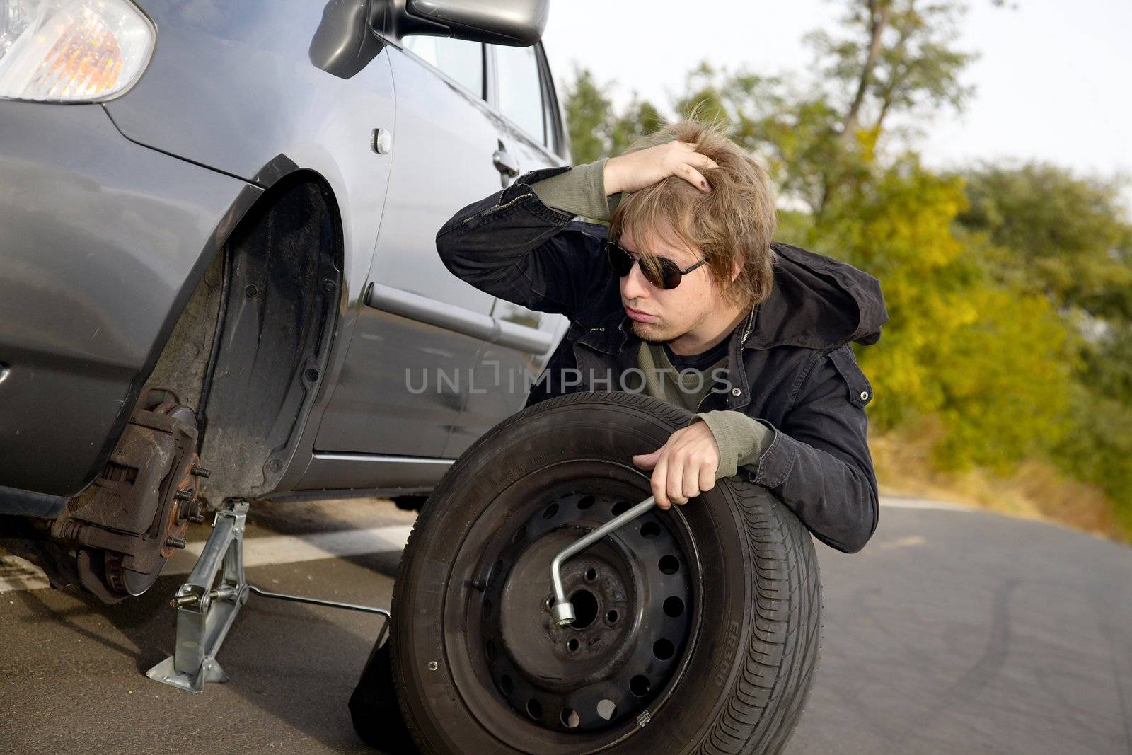 Man changing wheel on a car