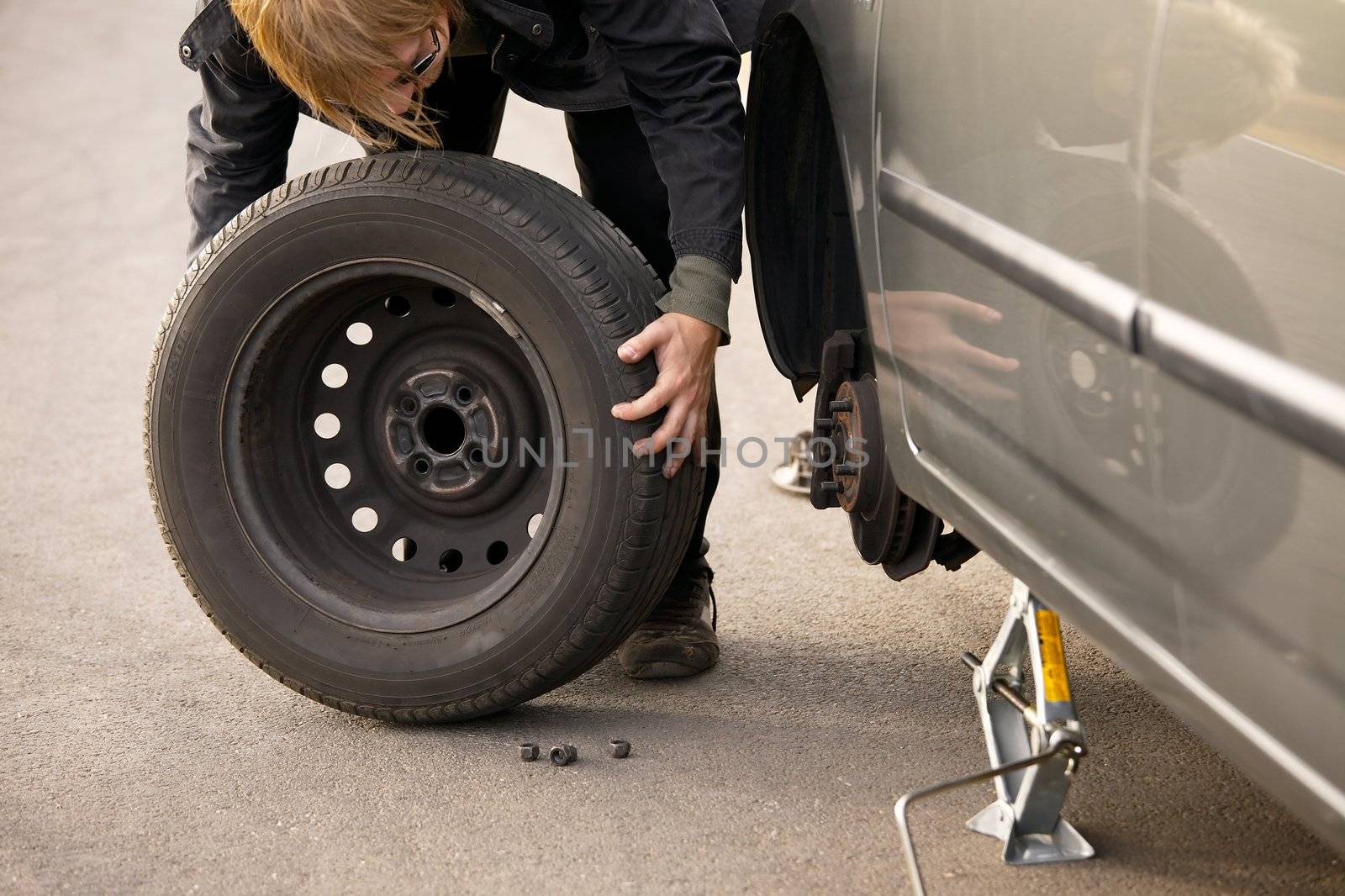 Changing wheel on a car on the roadside