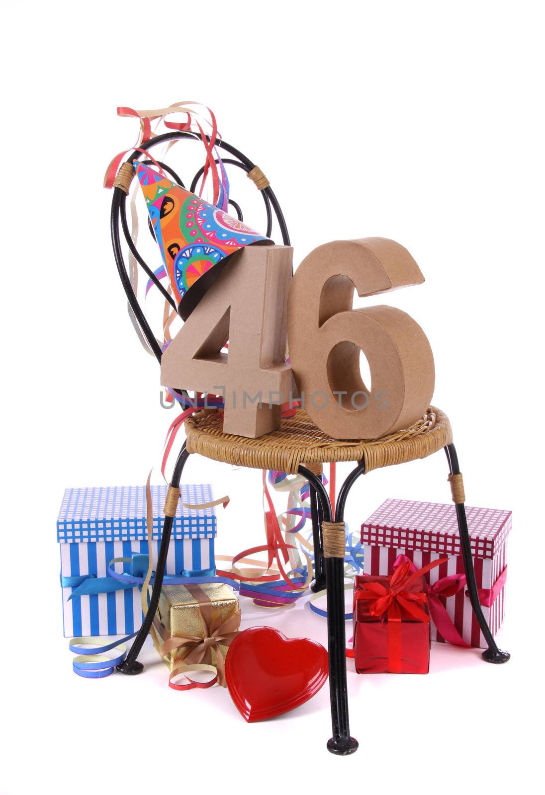 Number of age in a colorful studio setting with paper party hat and figures, a red heart and gifts