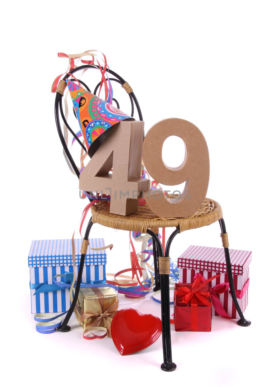 Number of age in a colorful studio setting with paper party hat and figures, a red heart and gifts