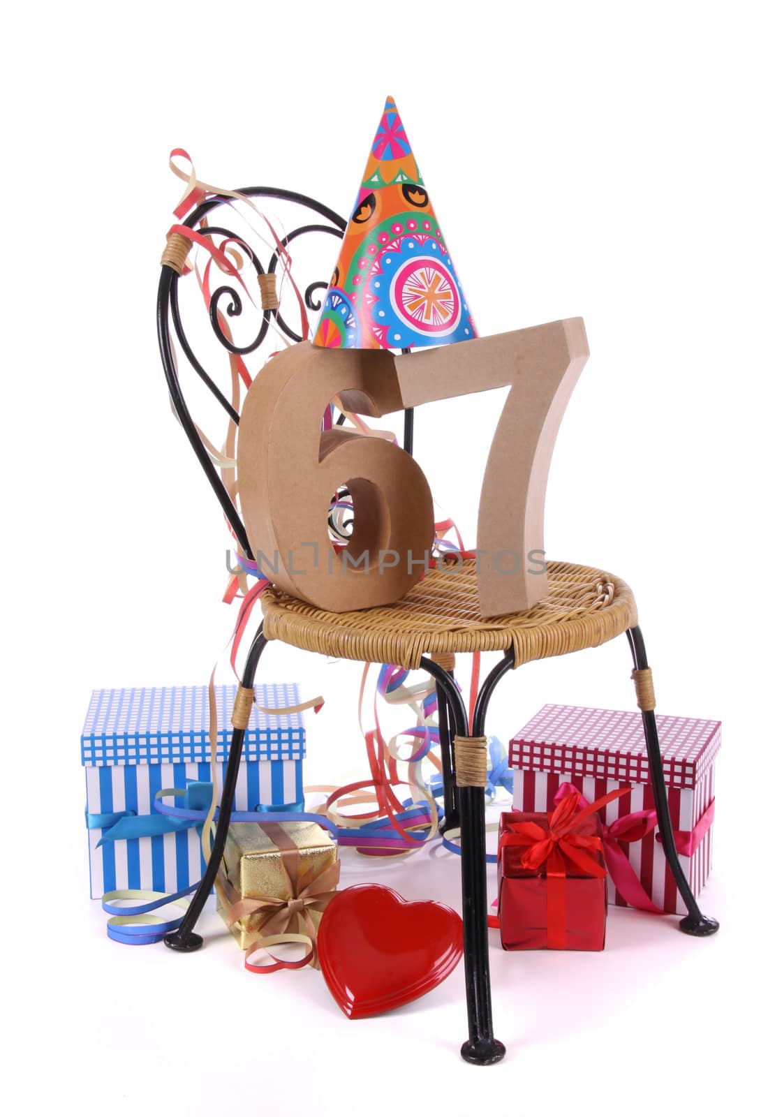 Number of age in a colorful studio setting with paper party hat and figures, a red heart and gifts