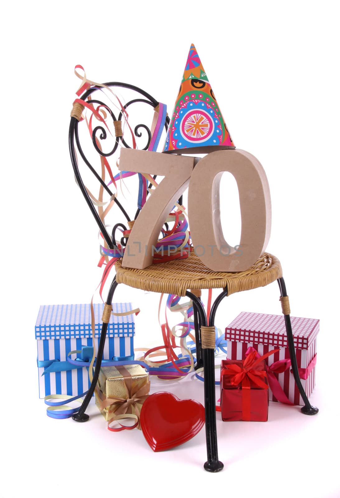 Number of age in a colorful studio setting with paper party hat and figures, a red heart and gifts