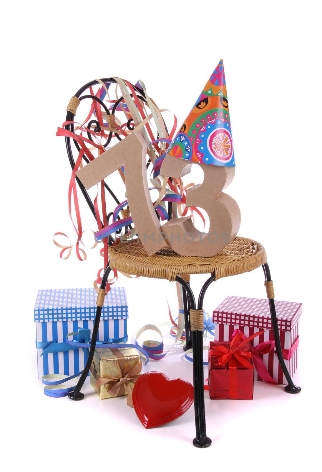 Number of age in a colorful studio setting with paper party hat and figures, a red heart and gifts