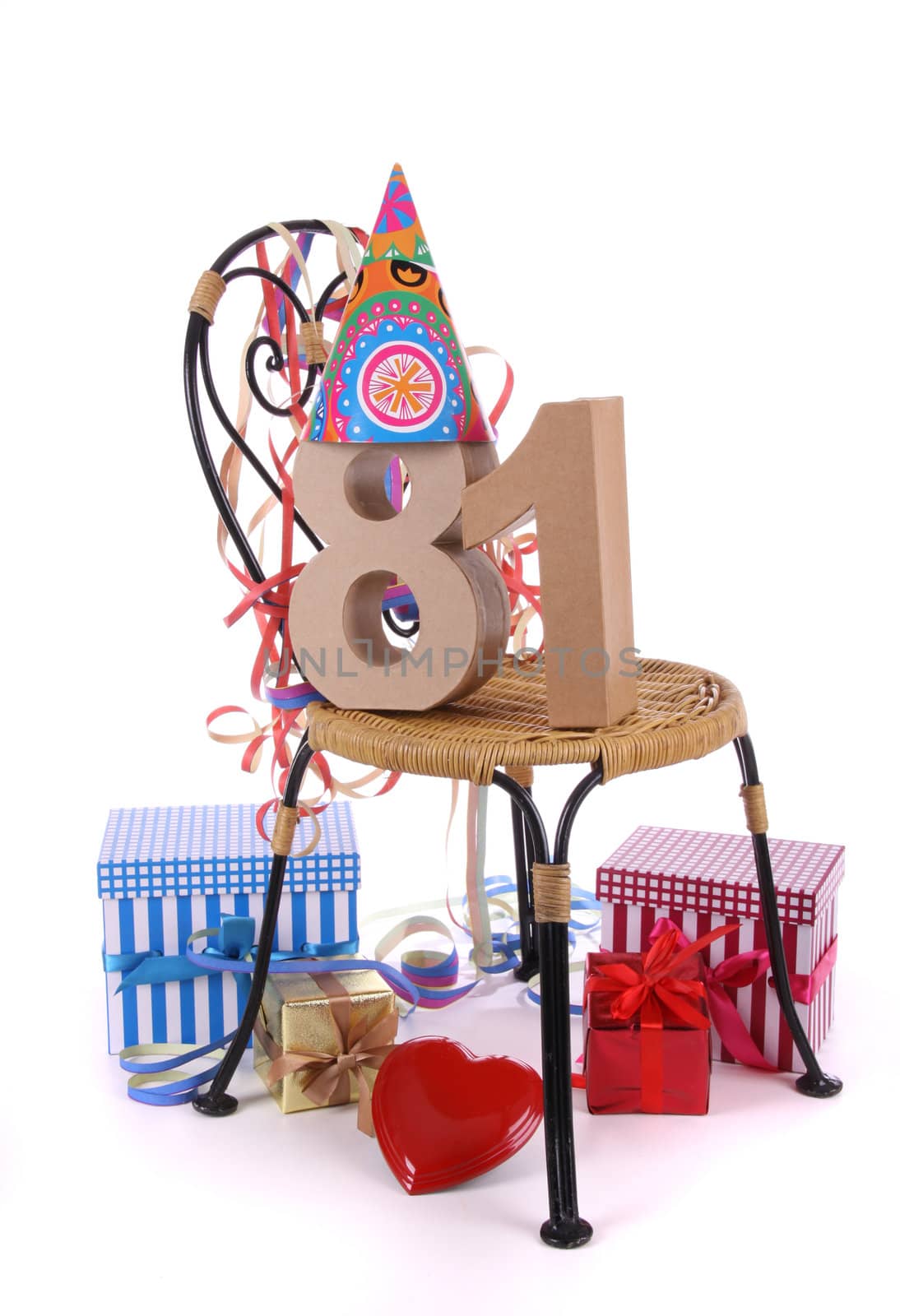 Number of age in a colorful studio setting with paper party hat and figures, a red heart and gifts