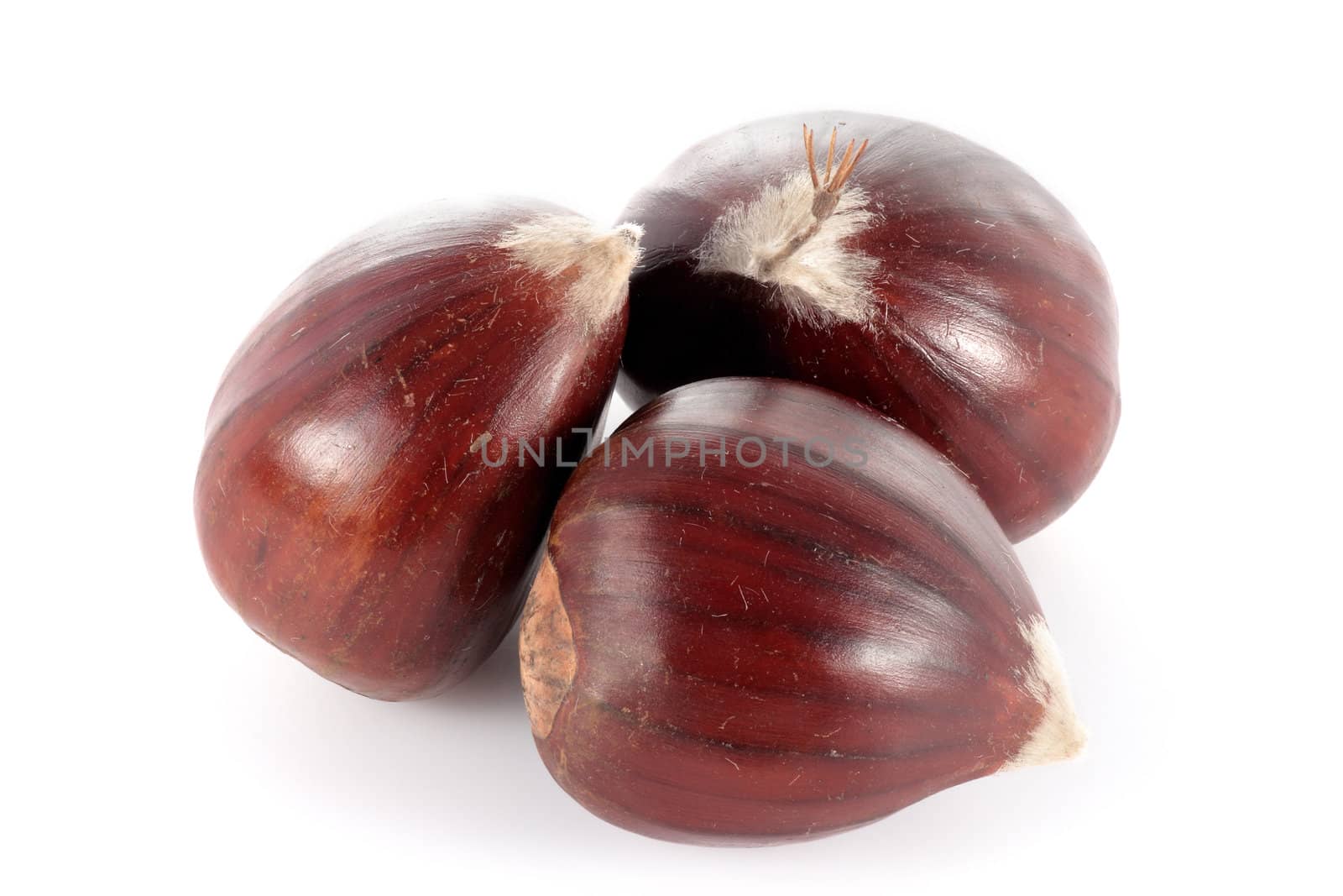 three heaped fresh chestnuts isolated on white