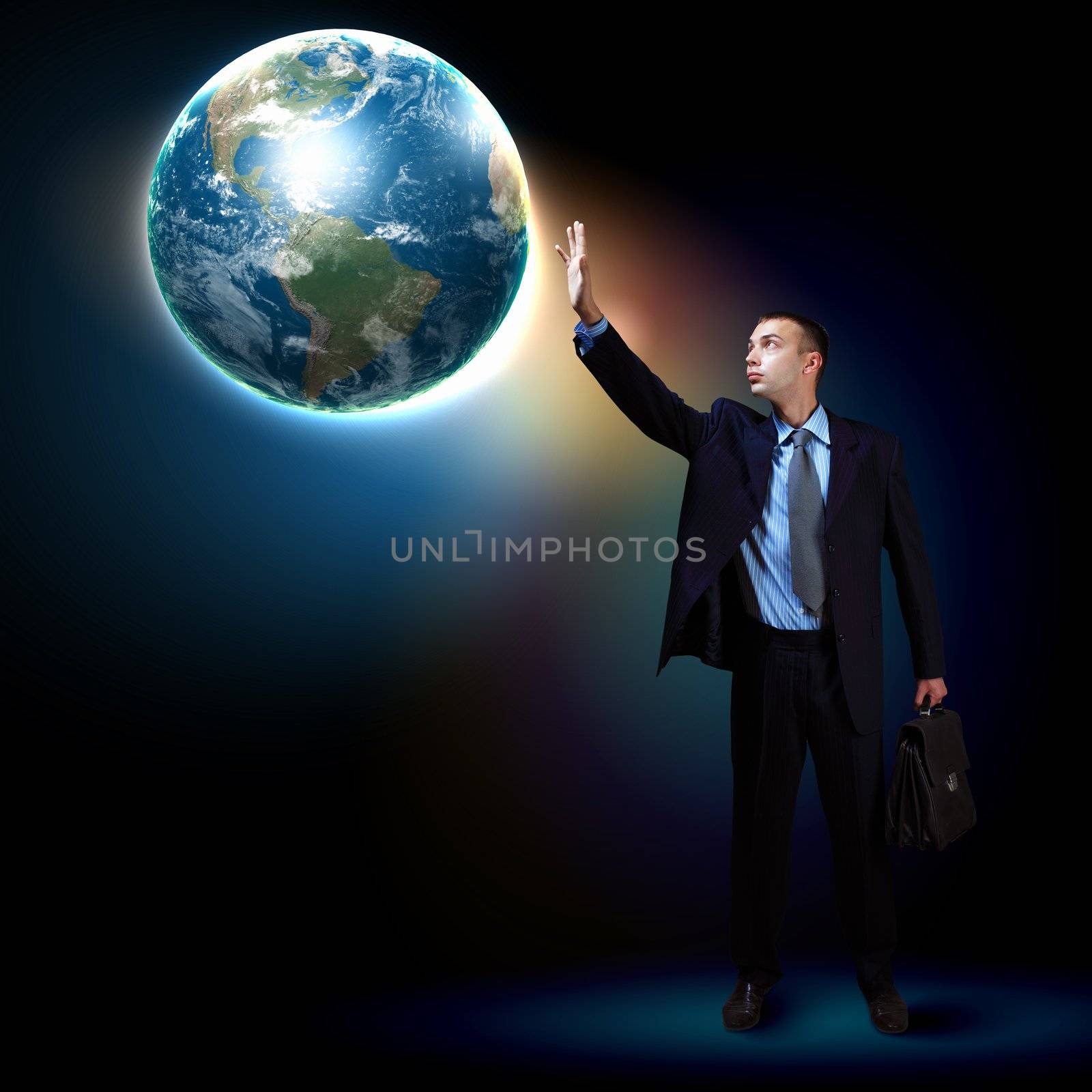 Businessman standing with our planet Earth. Elements of this image are furnished by NASA