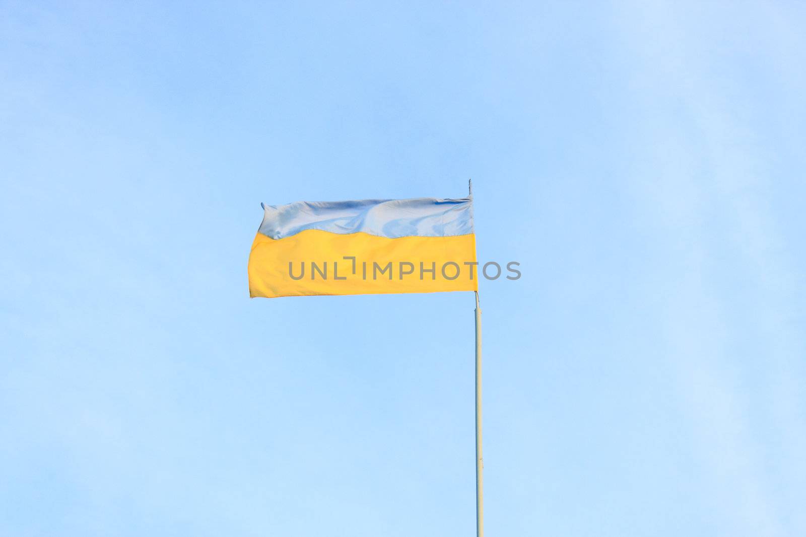 Ukrainian flag on a background of blue sky