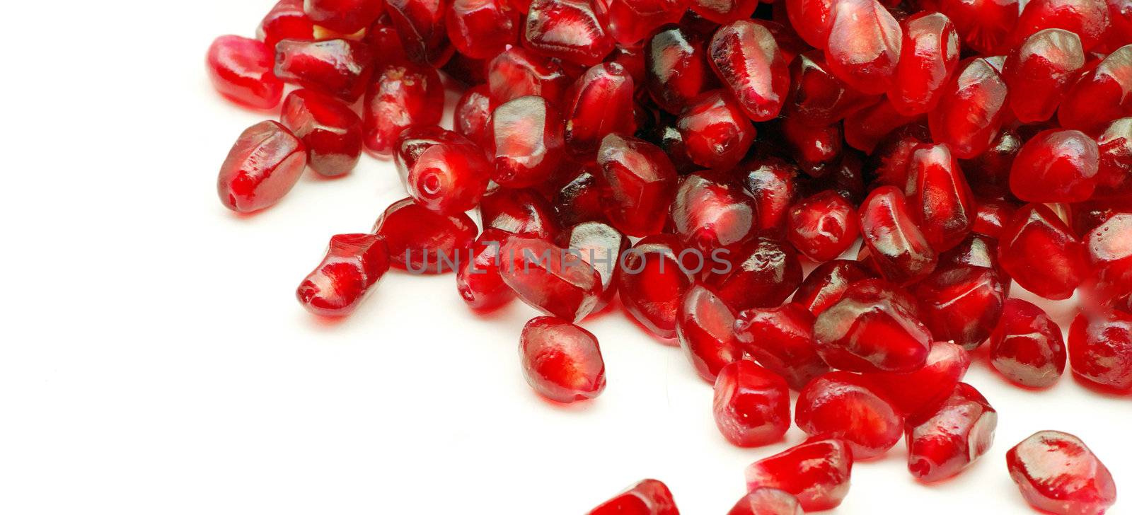 Some pomegranate berries isolated on the white background