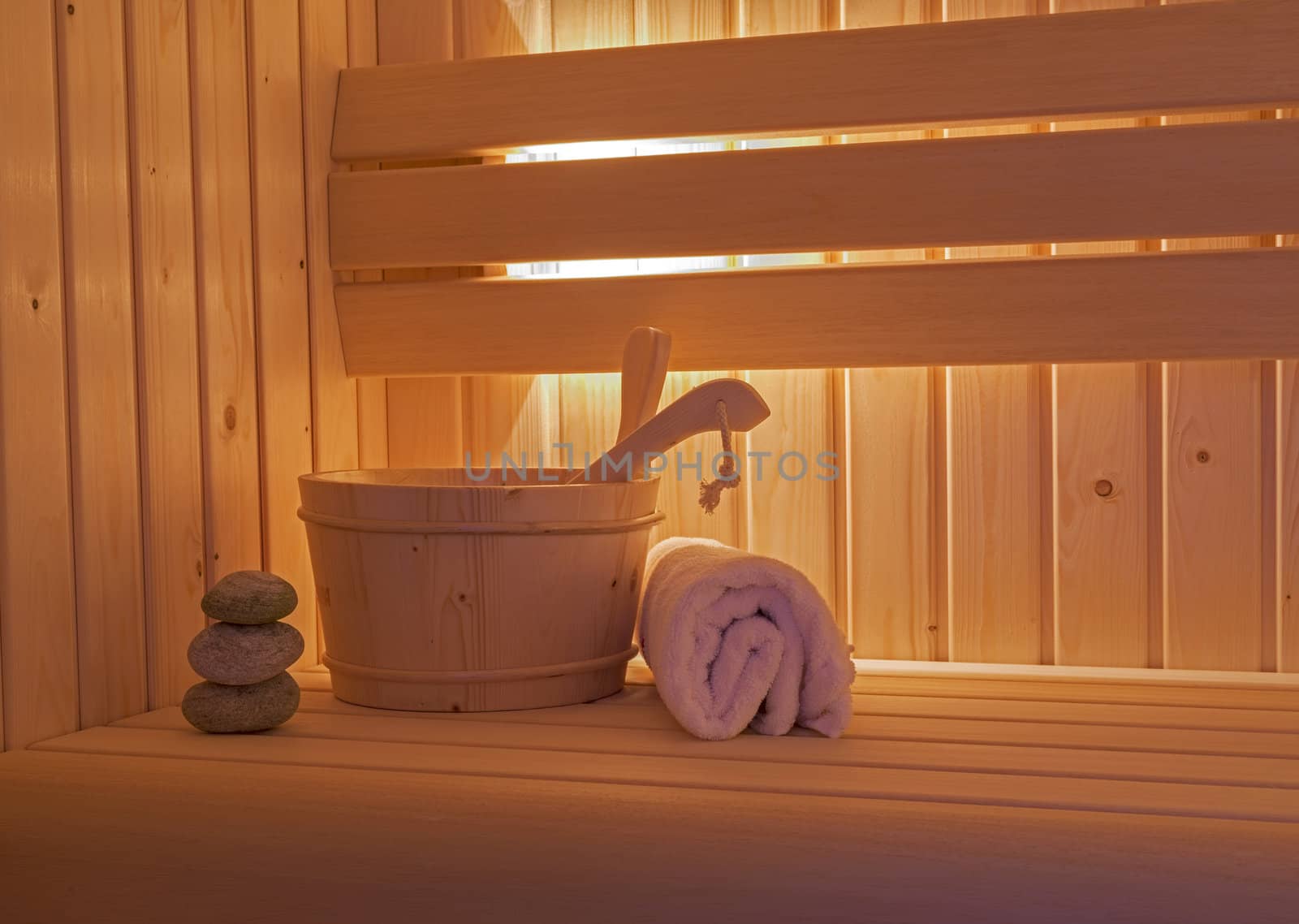 sauna interior with towels and wooden bucket