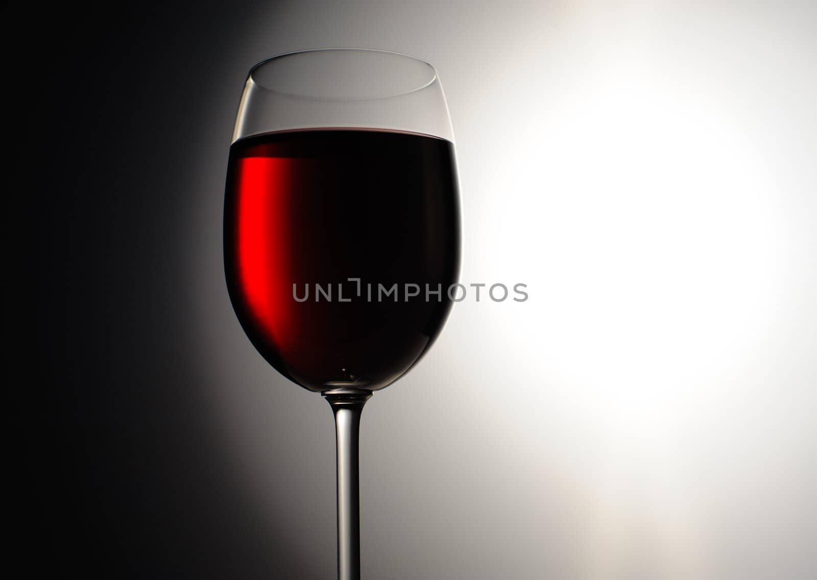 Closeup of red wine wineglass on dark background