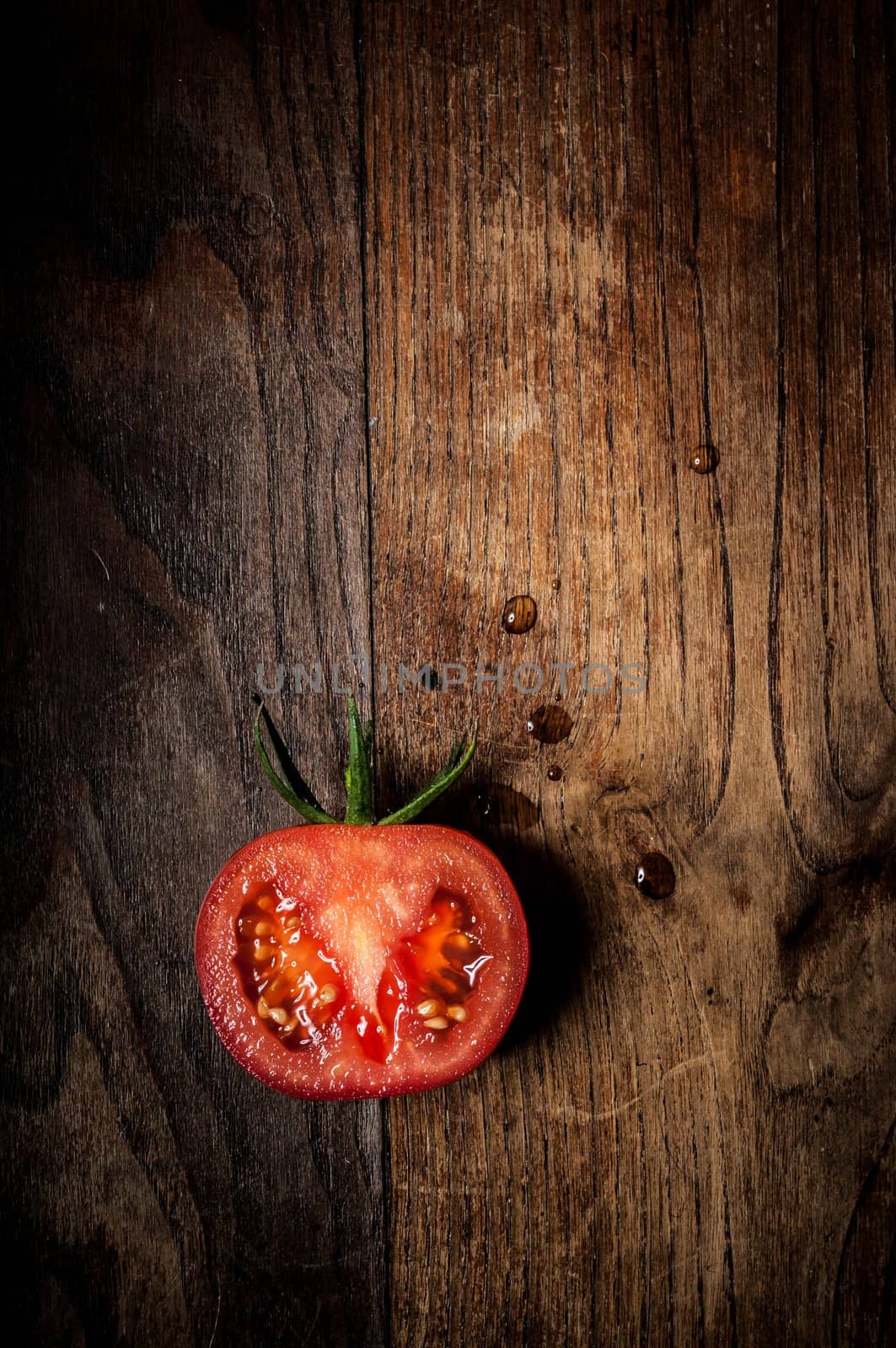 half tomato on wood by peus