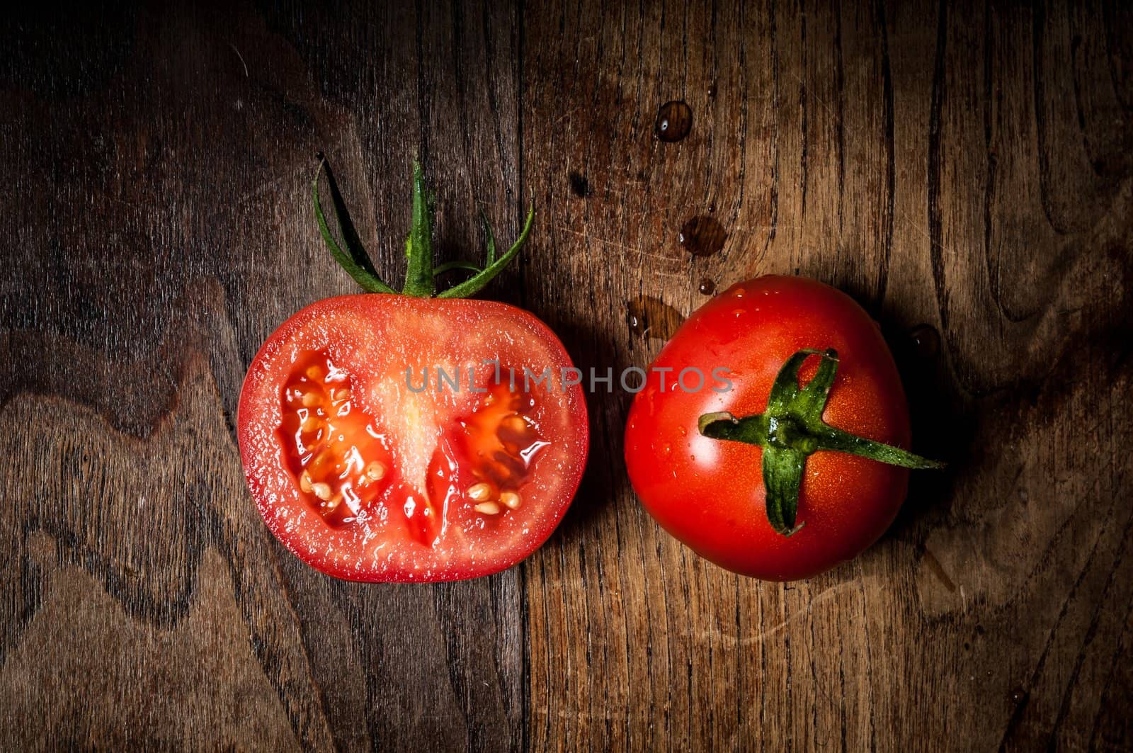 half and whole tomatoes on wood by peus