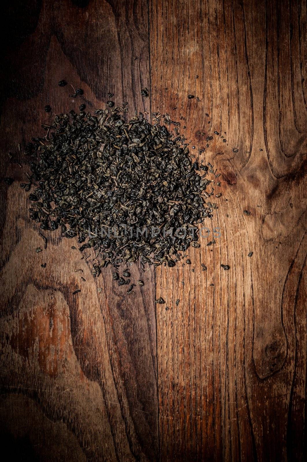 breen tea leaves on brown wood