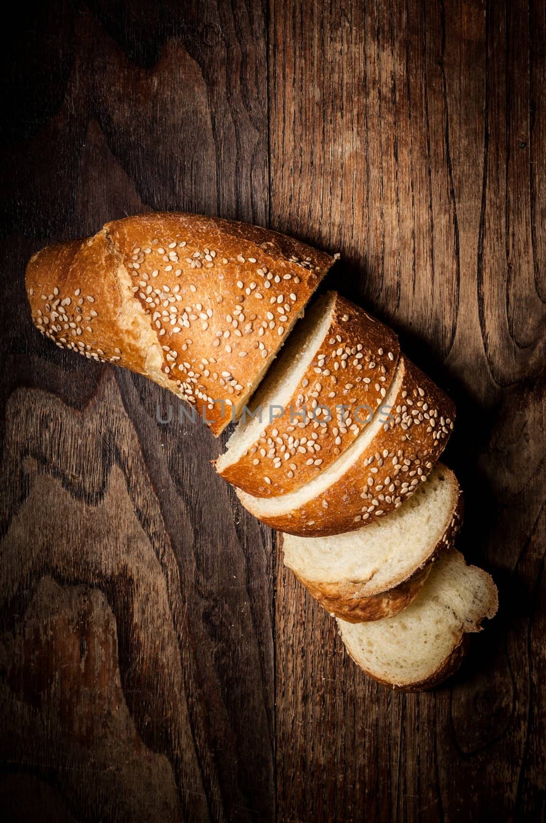 sliced wholemeal sesame bread on wood by peus