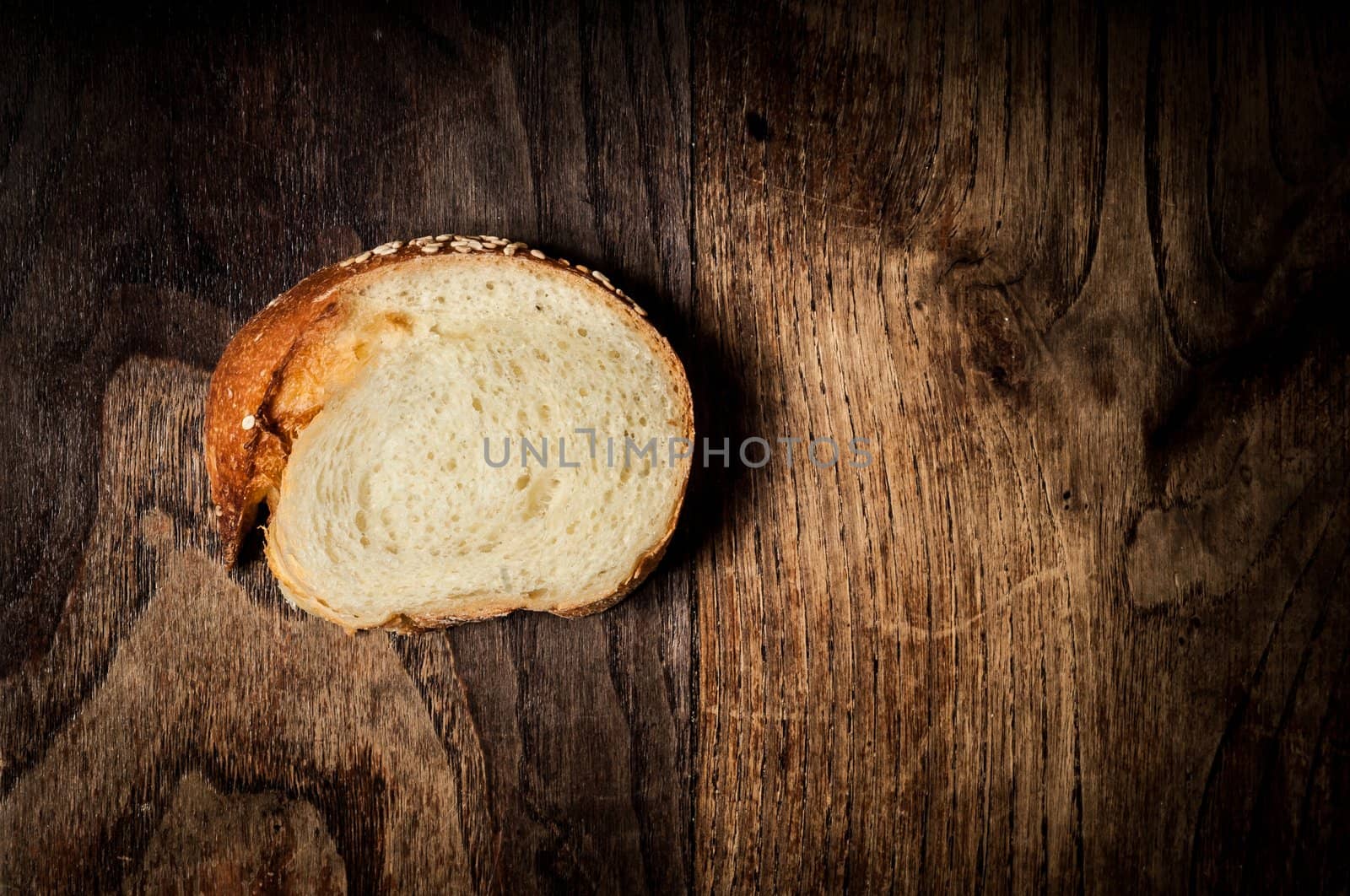 sliced wholemeal sesame bread on brown wood