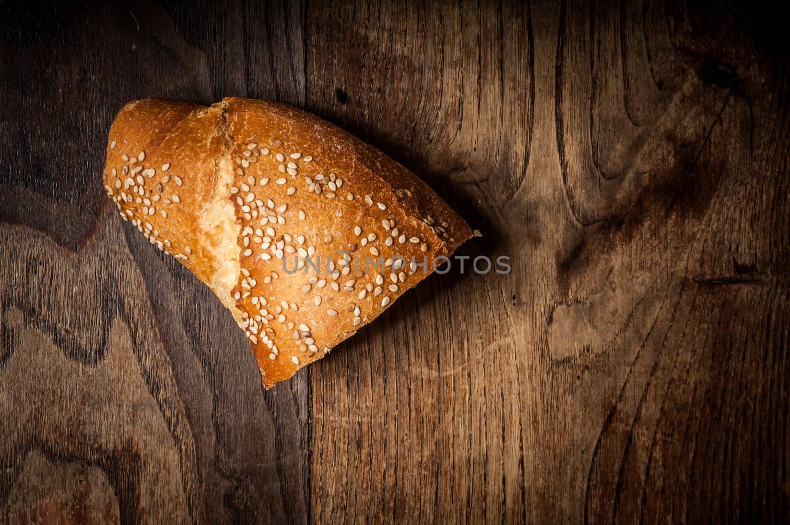 sliced wholemeal sesame bread on brown wood