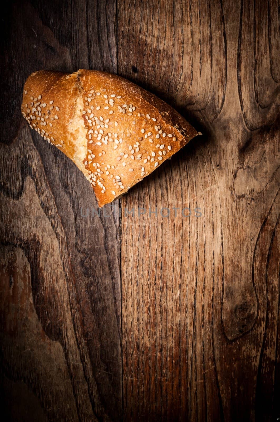 sliced wholemeal sesame bread on wood by peus